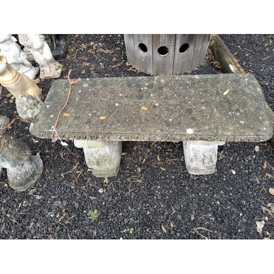 A CONCRETE GARDEN BENCH with scrolled supports, 96cm wide c...