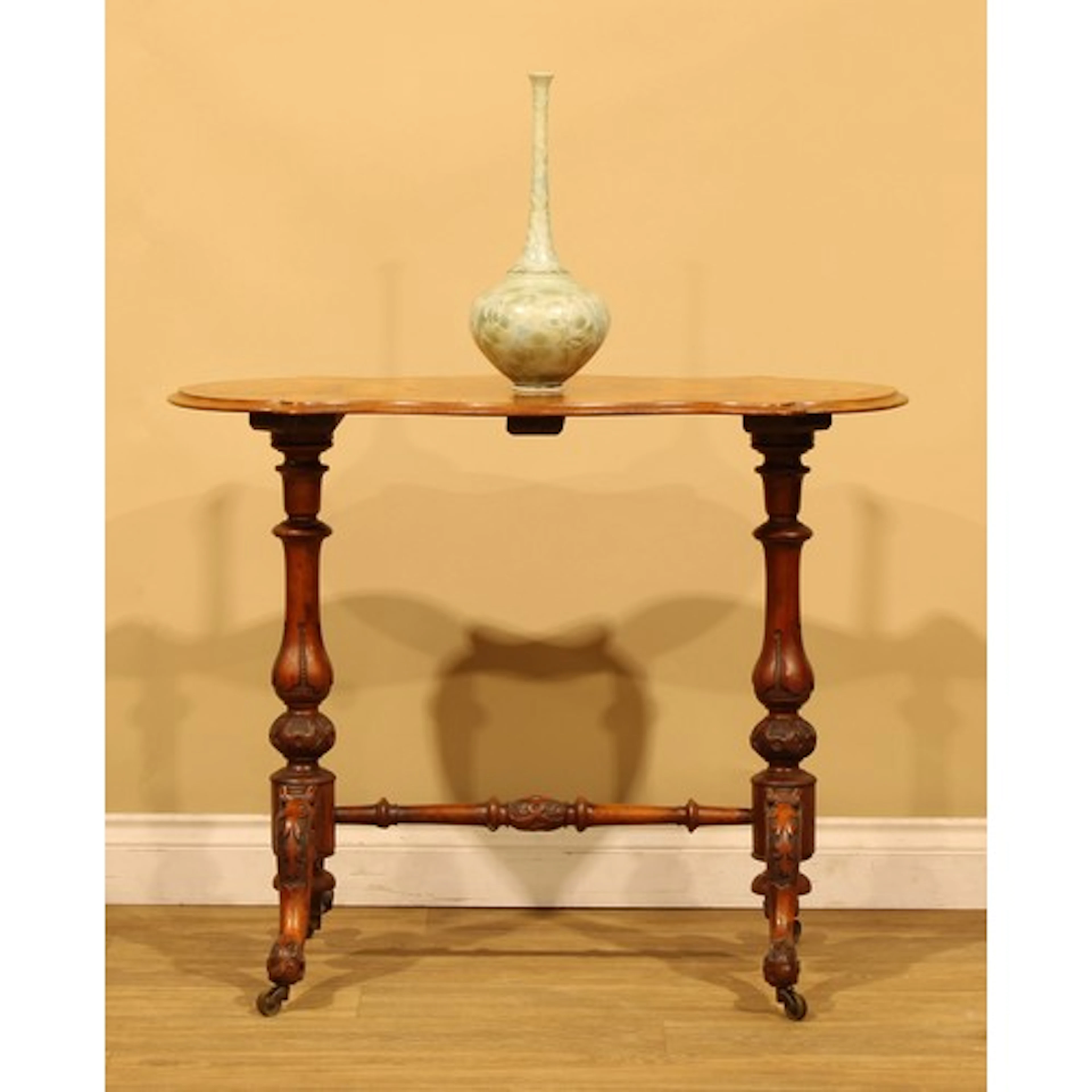 A Victorian walnut shaped serpentine centre table, quarter-v...