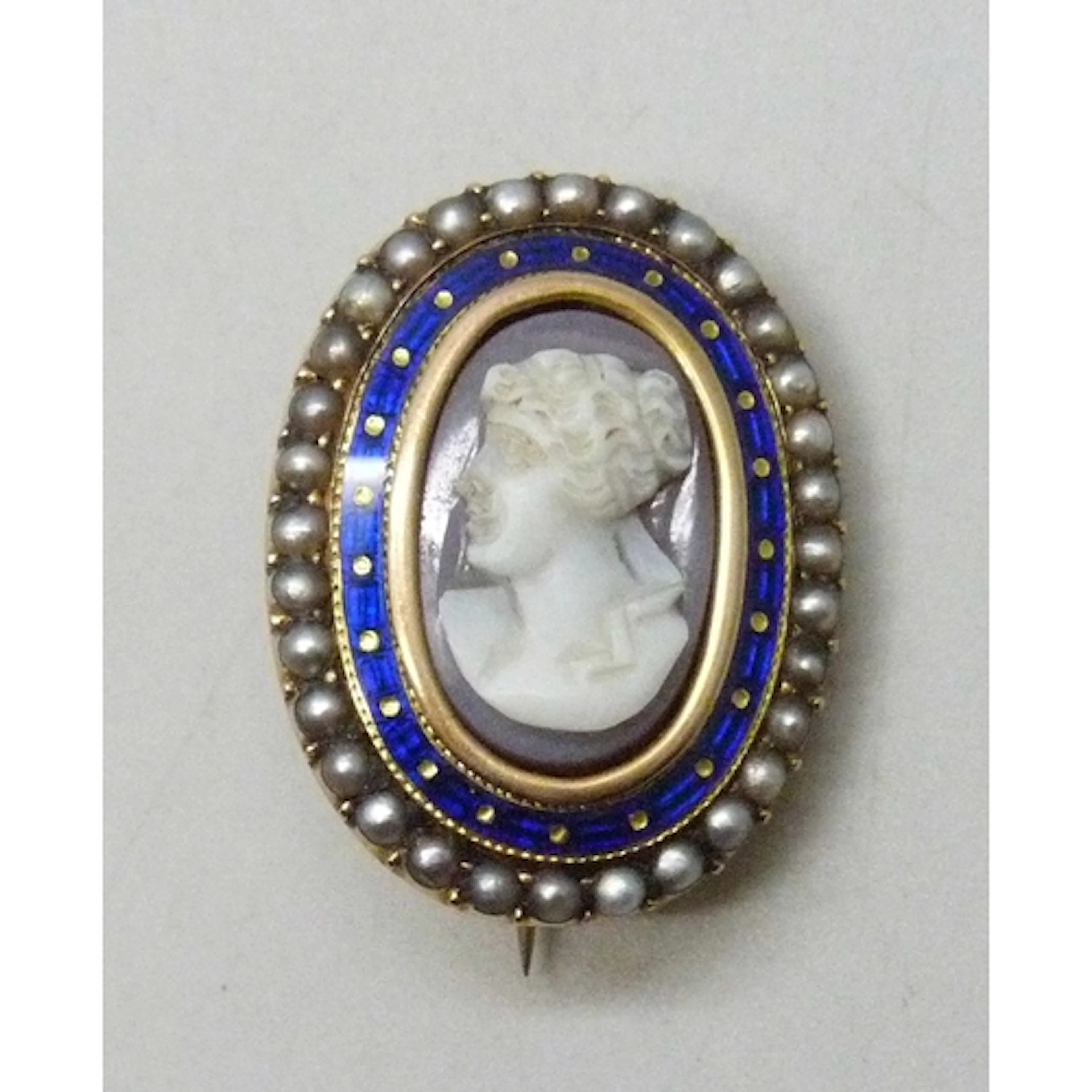 A 19th century yellow metal cameo brooch with enamel and see...