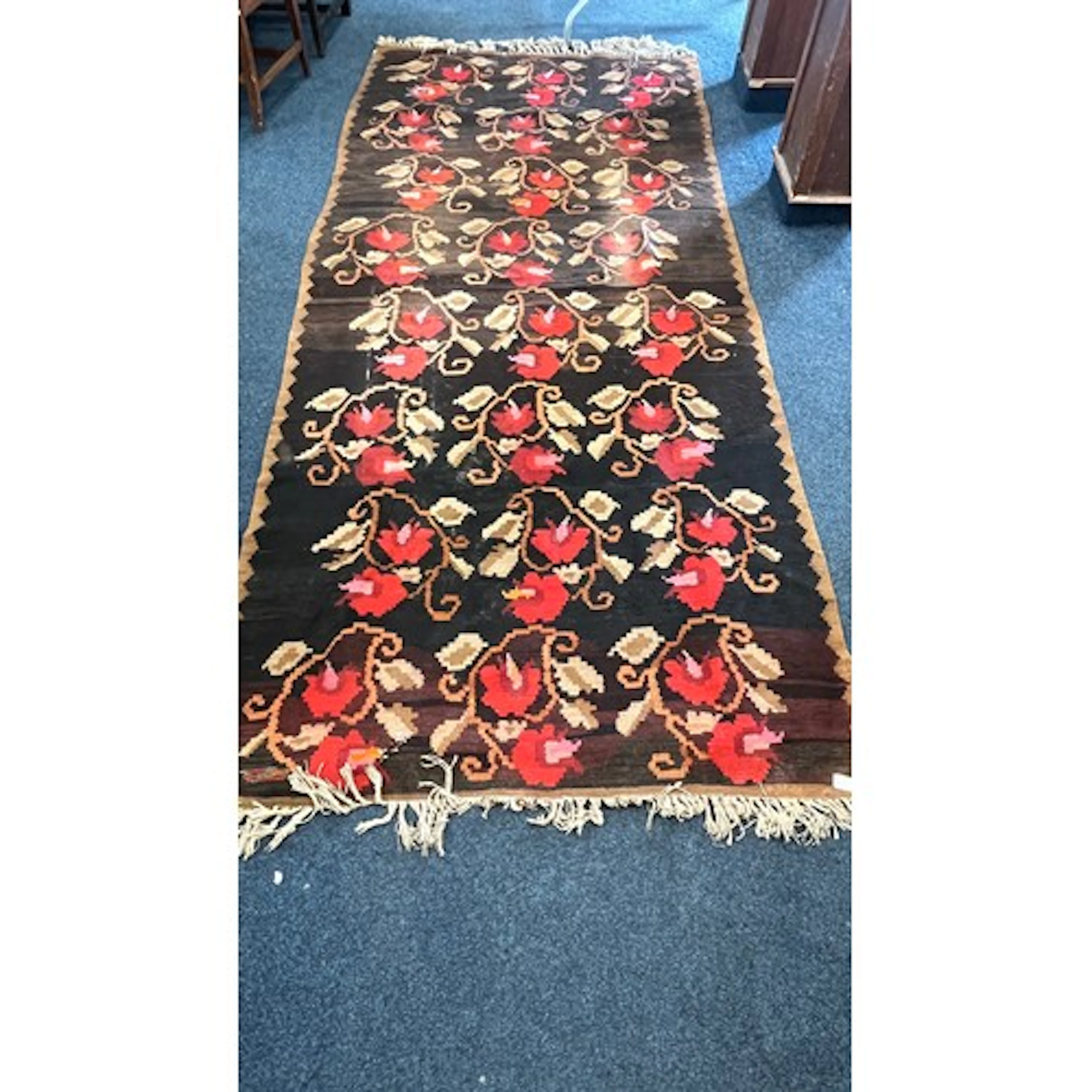 Two old kelim rugs, the first with black ground and floral s...