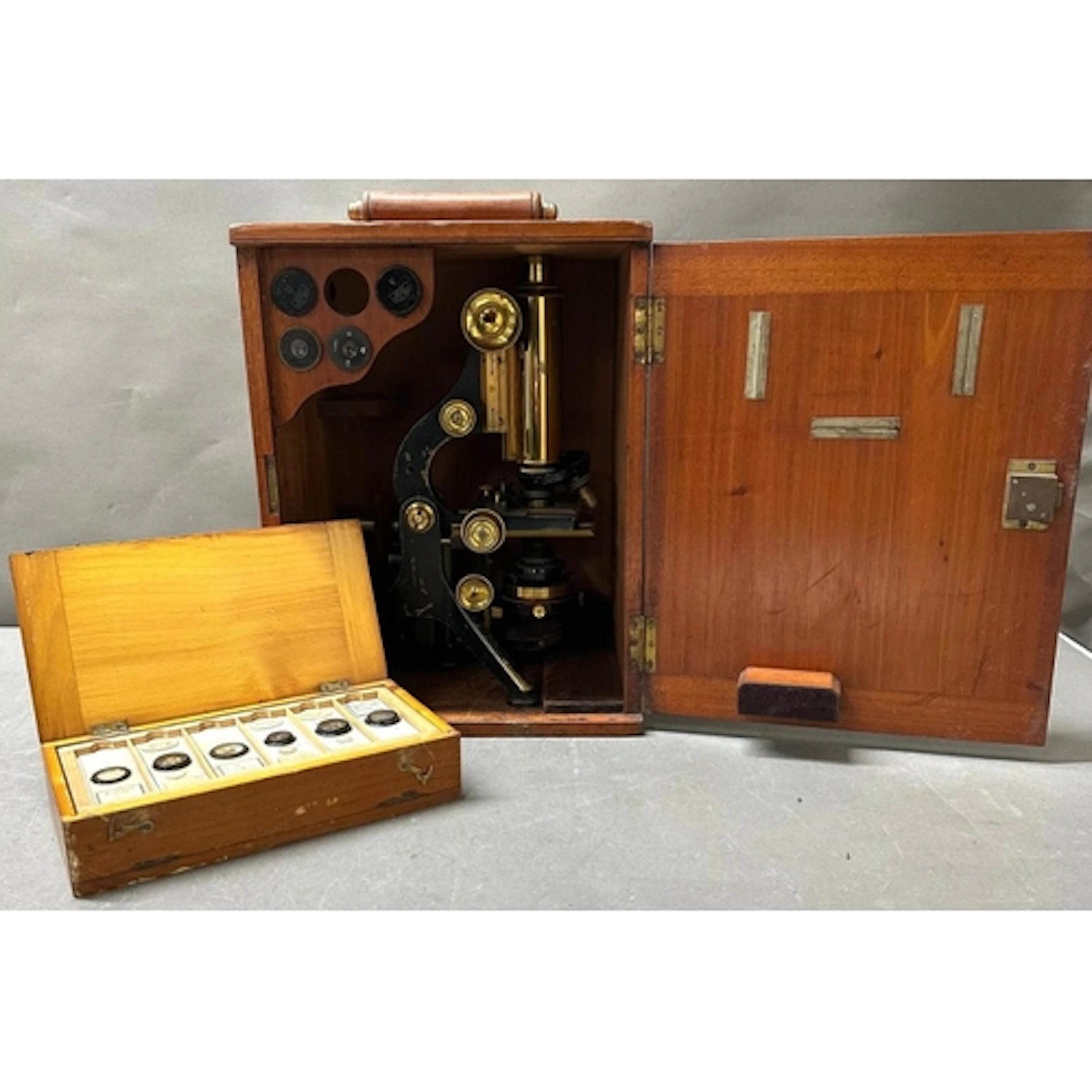 An antique brass and iron microscope produced by W.Watson an...