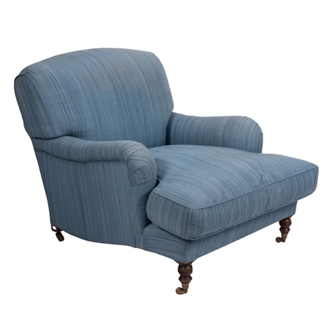 An upholstered lounge armchair in the style of examples by H...