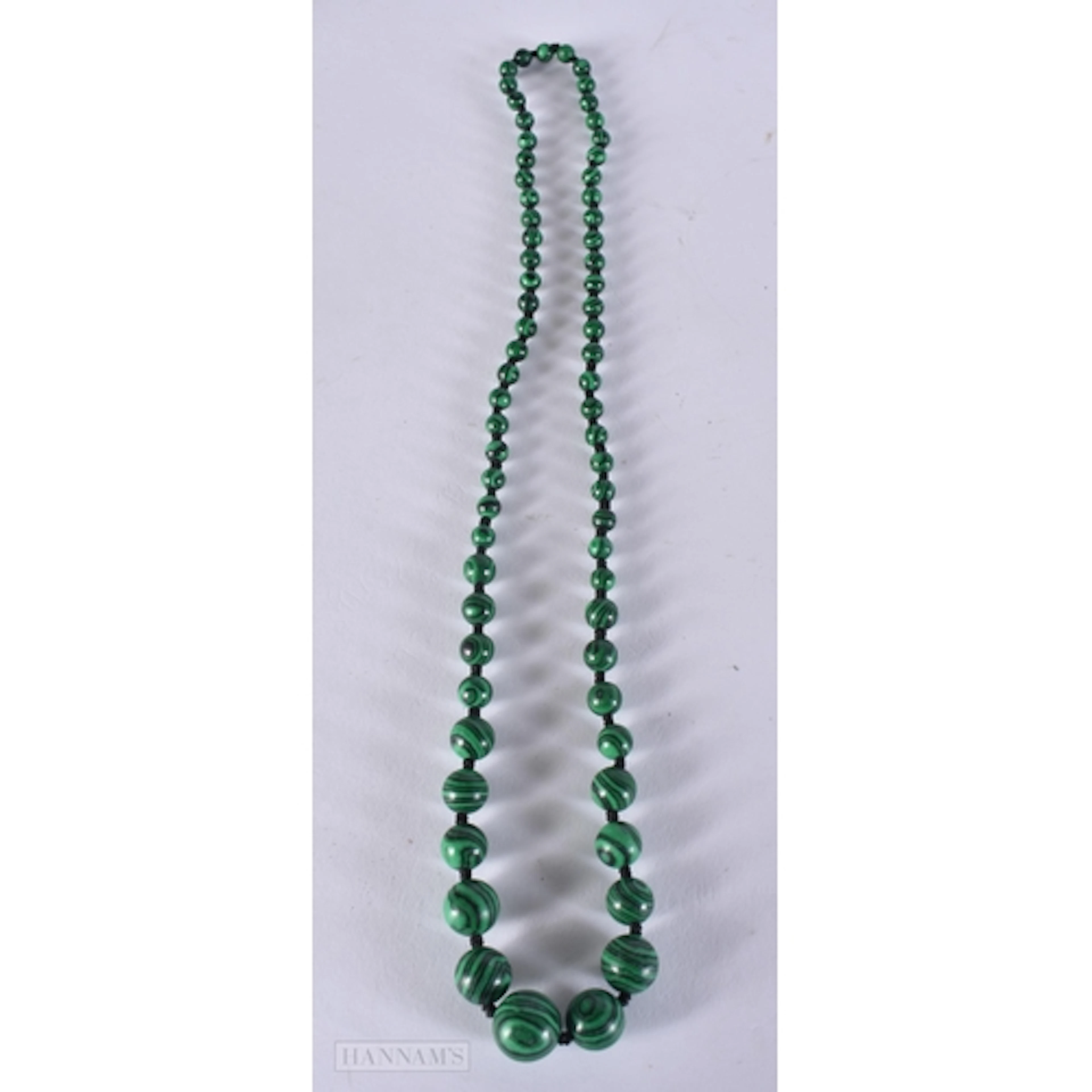 A MALACHITE STRING BEAD NECKLACE. 64 cm