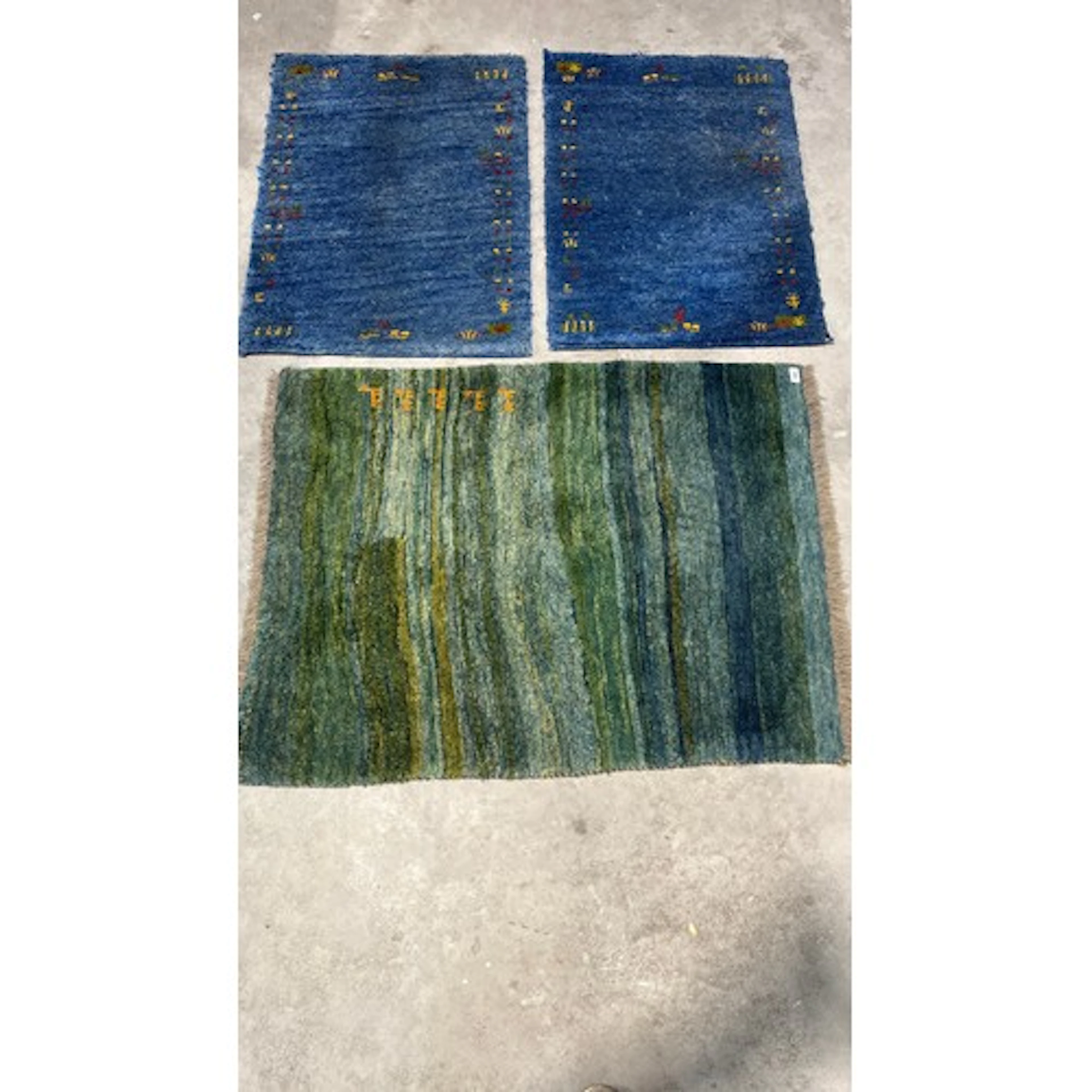 Pair of blue ground tribal style rugs and a further green gr...