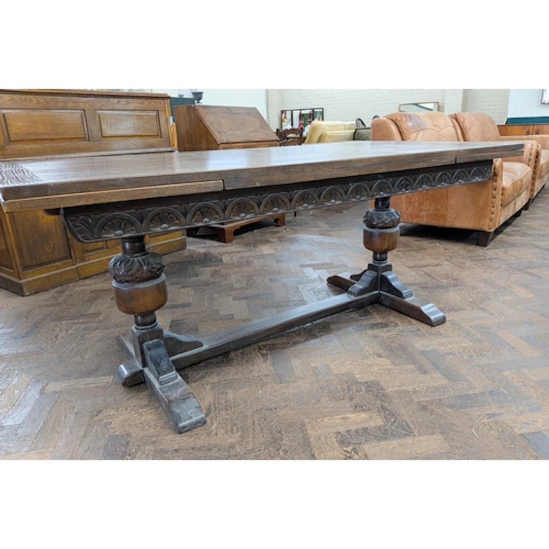 An oak refectory style drawer leaf dining table standing on ...