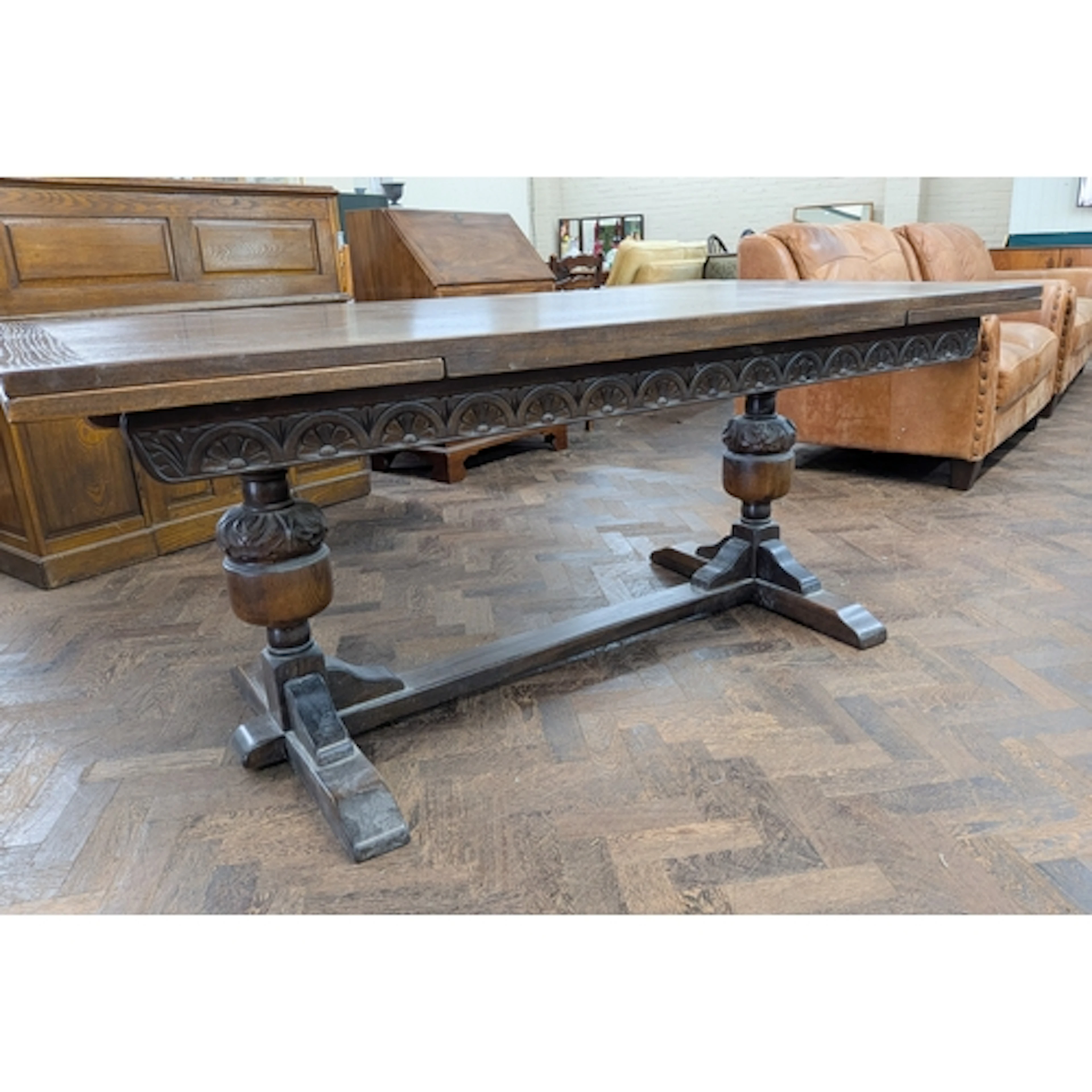 An oak refectory style drawer leaf dining table standing on ...