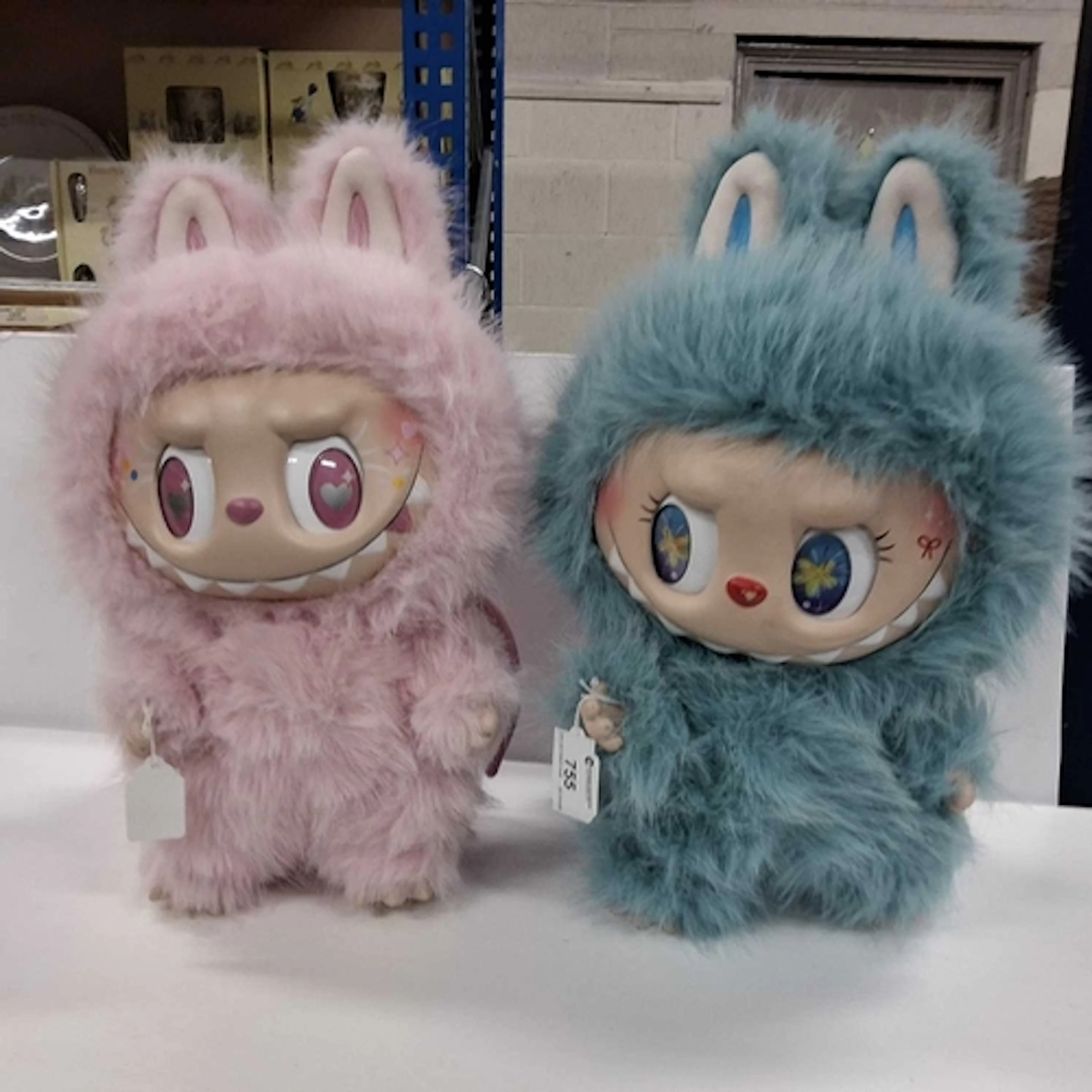 TWO LABUBU STYLE MONSTERS PLUSH FIGURES comprising a pink mo...