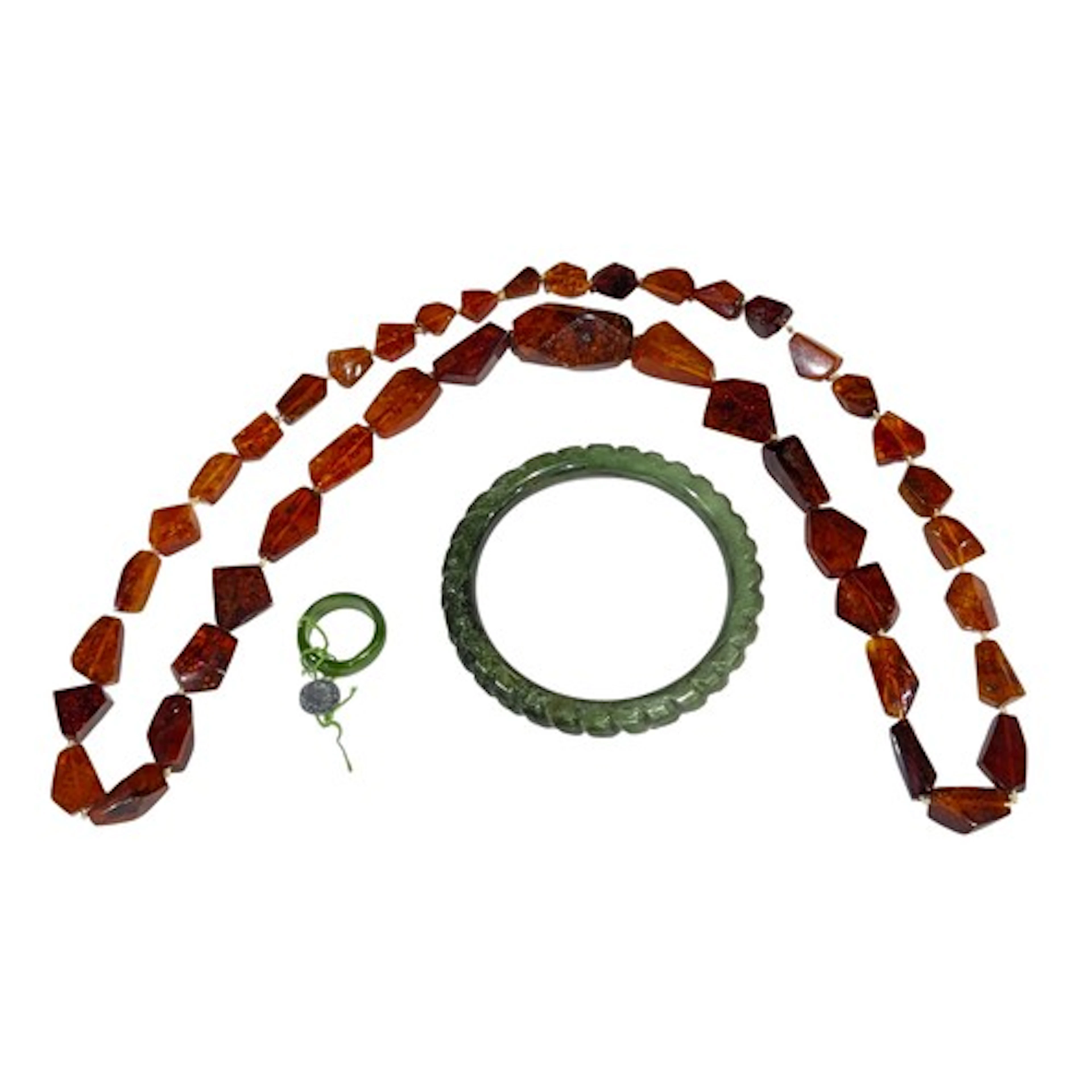 A Baltic amber graduated necklace, approx. 39cm; a green jad...