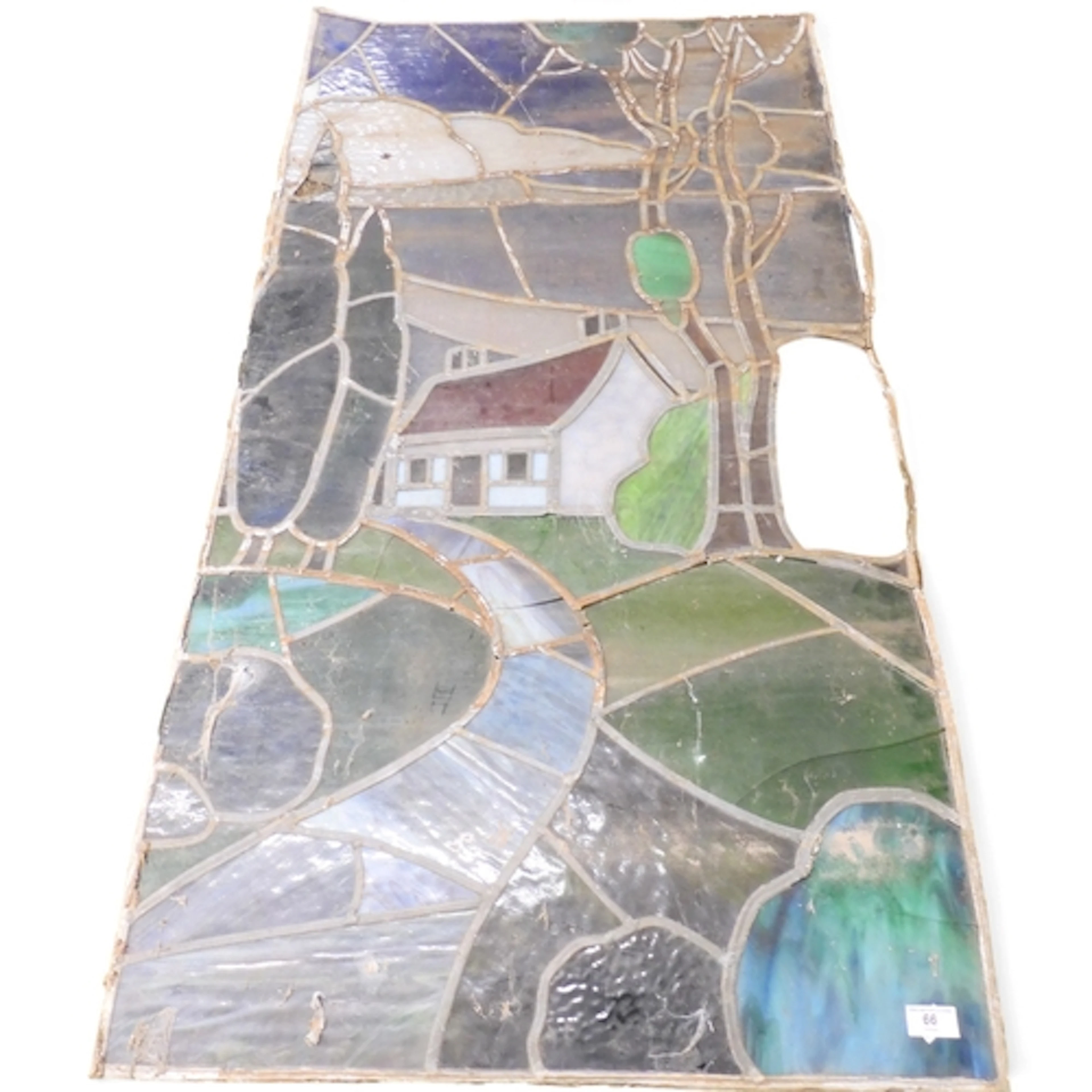 A large leaded stained glass panel depicting a rural cottage...