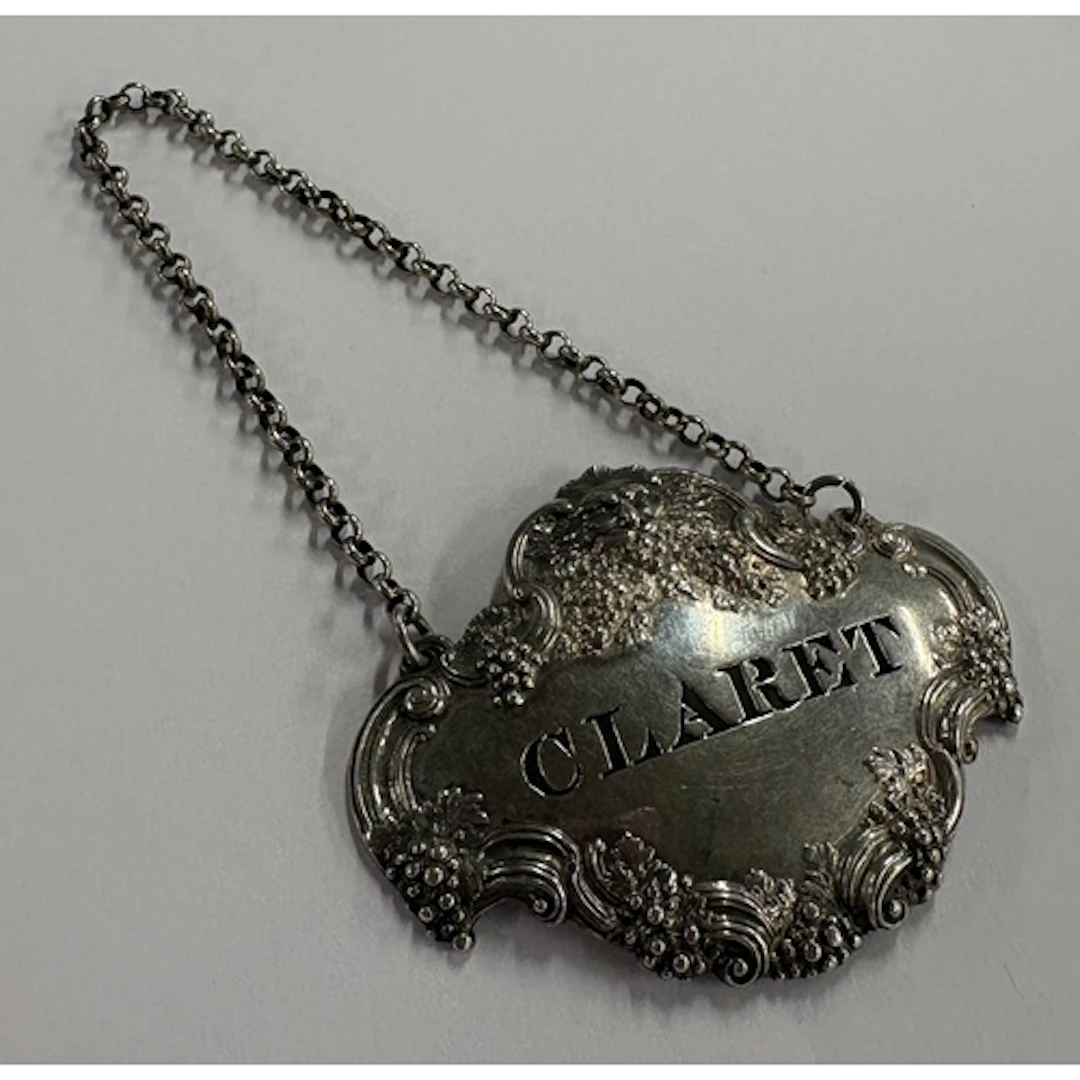 A cast Victorian silver wine label for 'Claret' with vine de...
