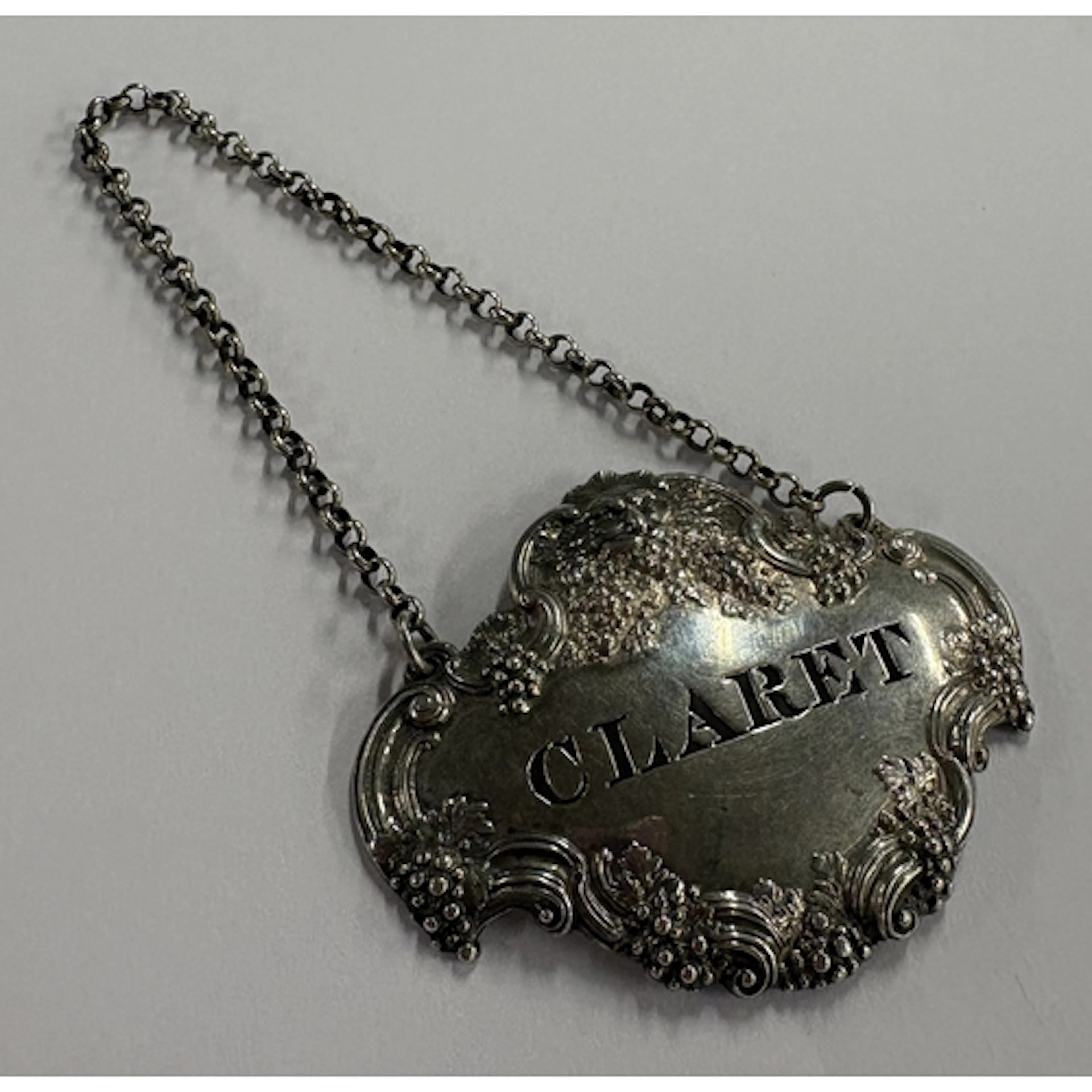 A cast Victorian silver wine label for 'Claret' with vine de...