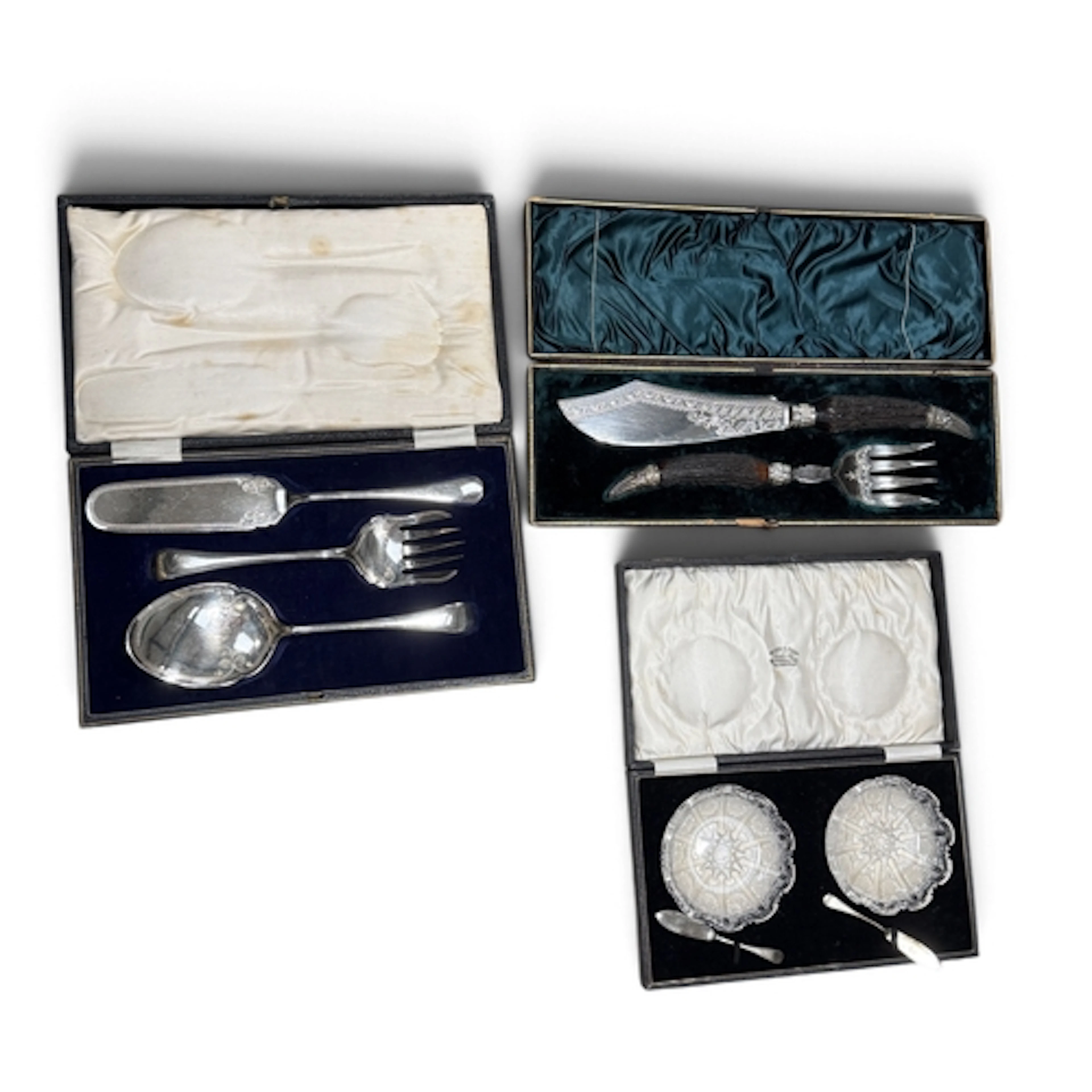 A CASED PAIR OF CUT GLASS BUTTER DISHES AND A PAIR OF SILVER...
