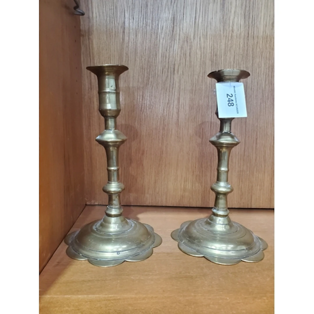 A pair of 18th century brass candlesticks with knopped stems...