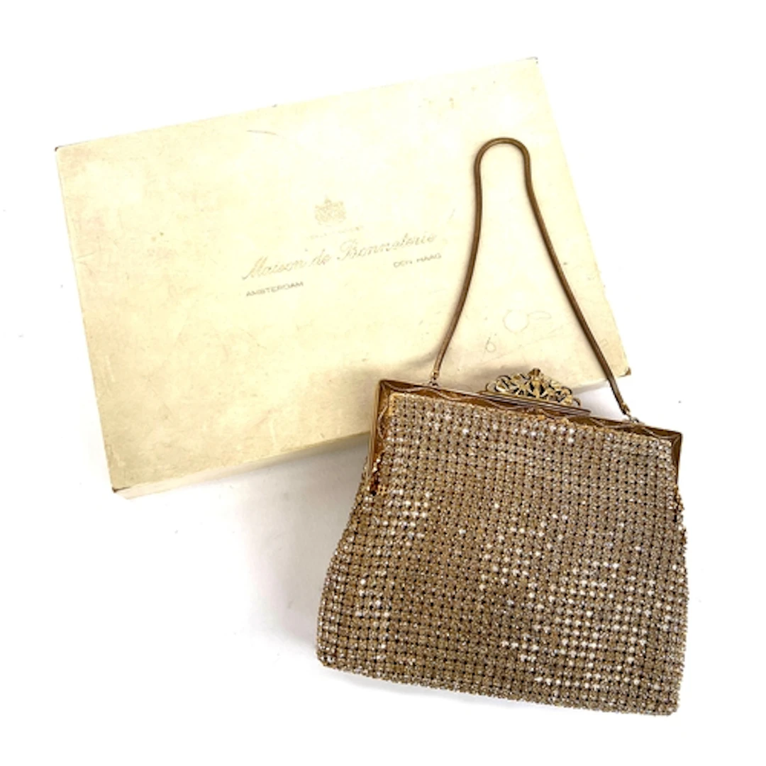 An early 20th century gilt metal evening bag set with rhines...