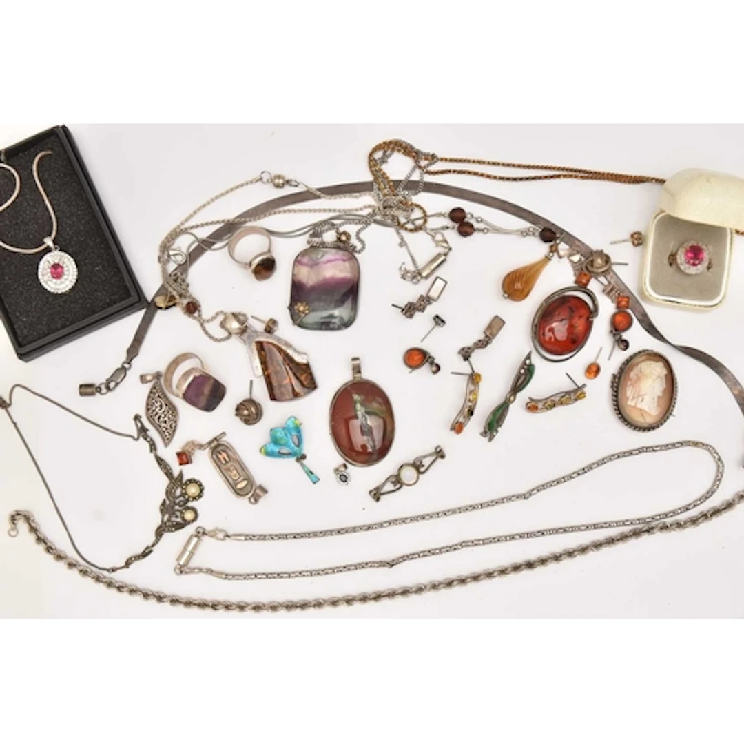 AN ASSORTMENT OF WHITE METAL JEWELLERY, to include three lar...