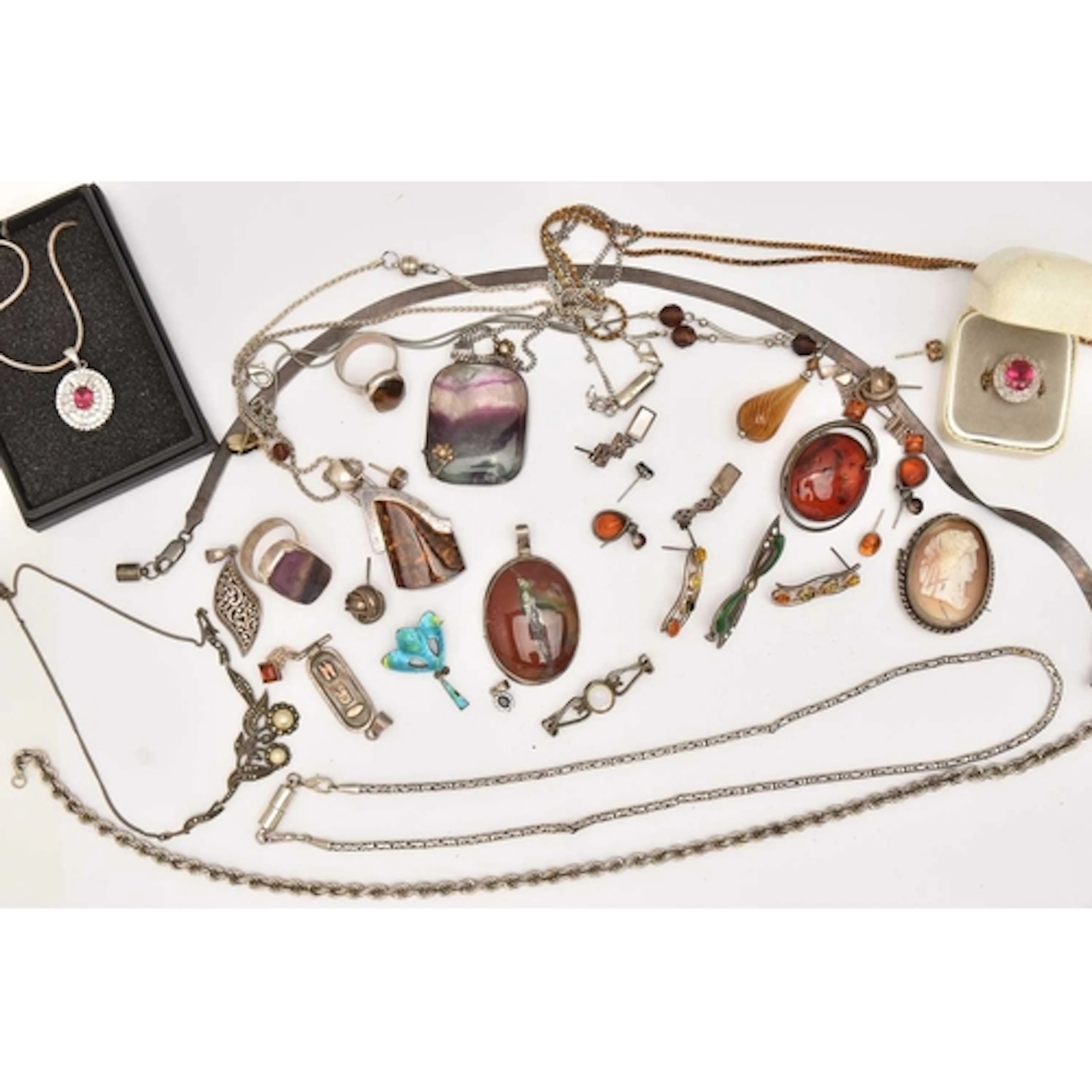 AN ASSORTMENT OF WHITE METAL JEWELLERY, to include three lar...