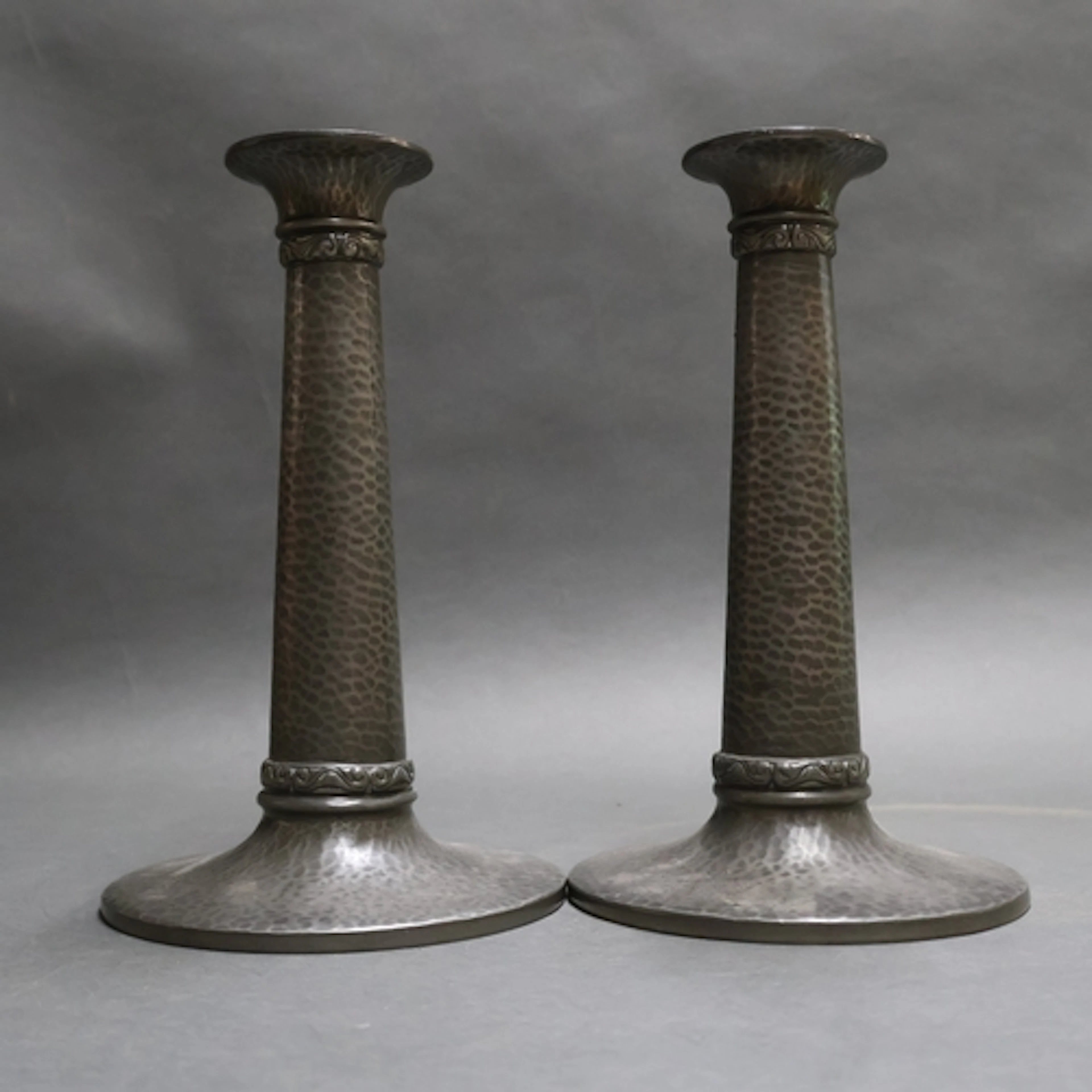 Tudric, Liberty - A pair of Arts & Crafts pewter candlestick...