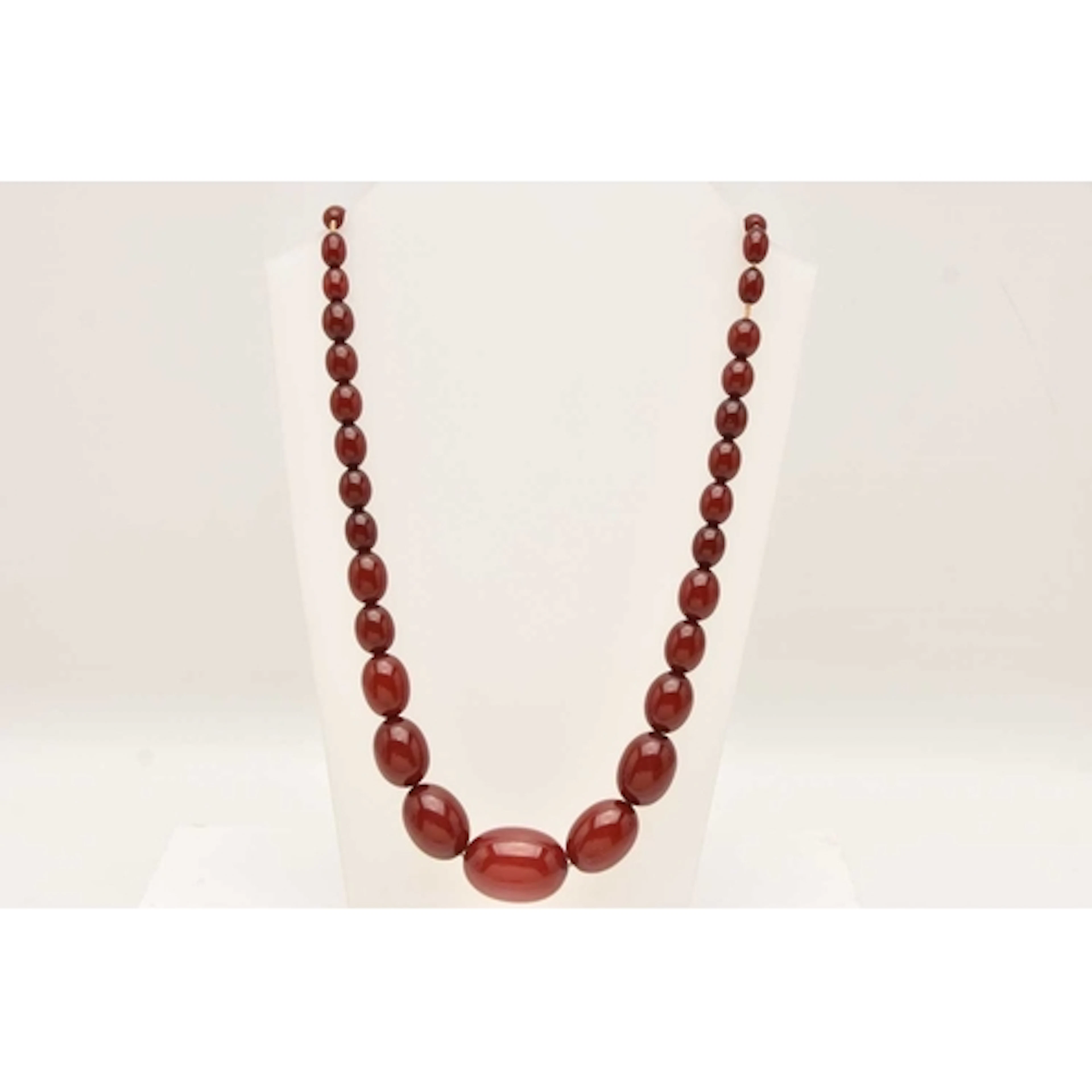 A BAKELITE BEAD NECKLACE, cherry amber colour Bakelite beads...