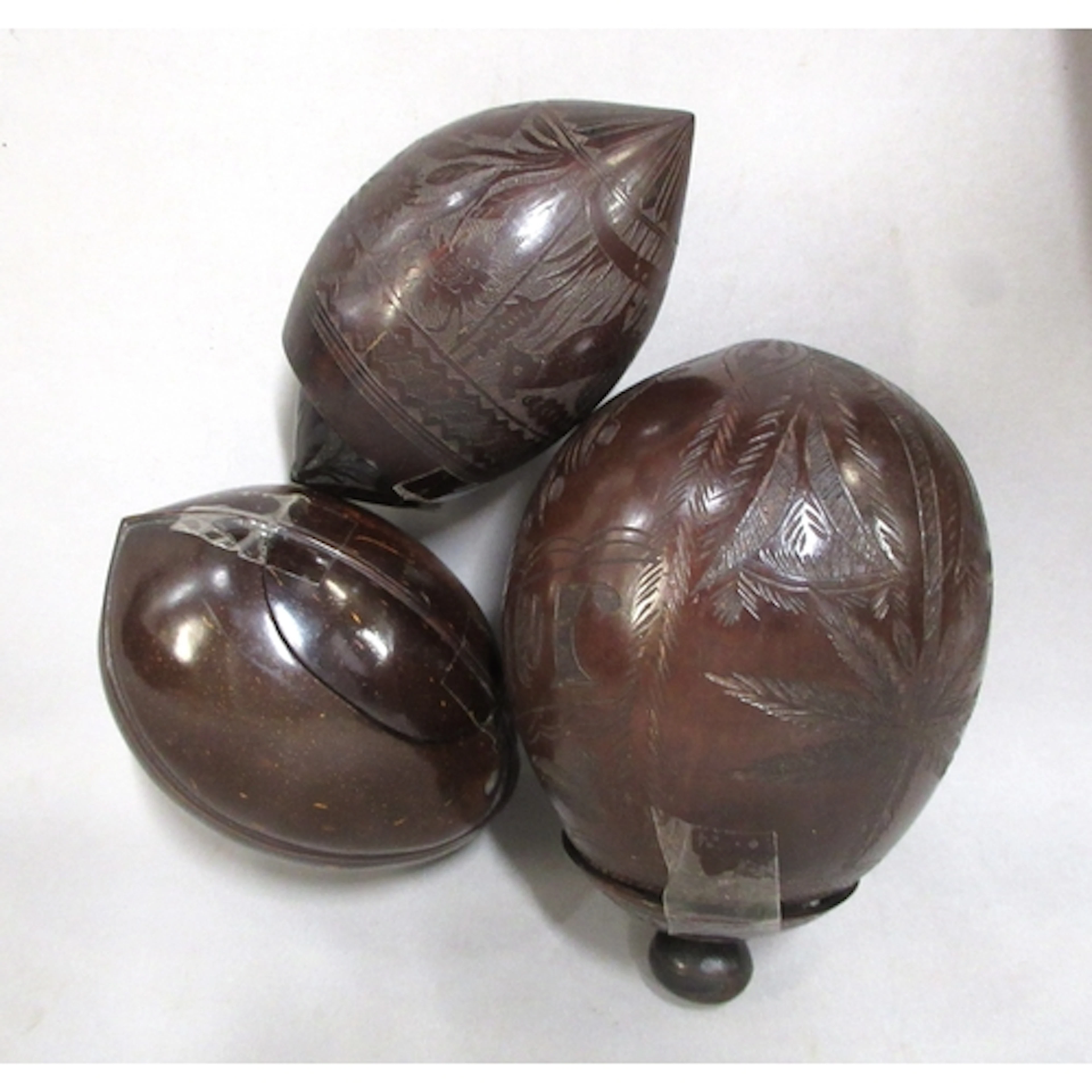 Three carved and polished coconut shells