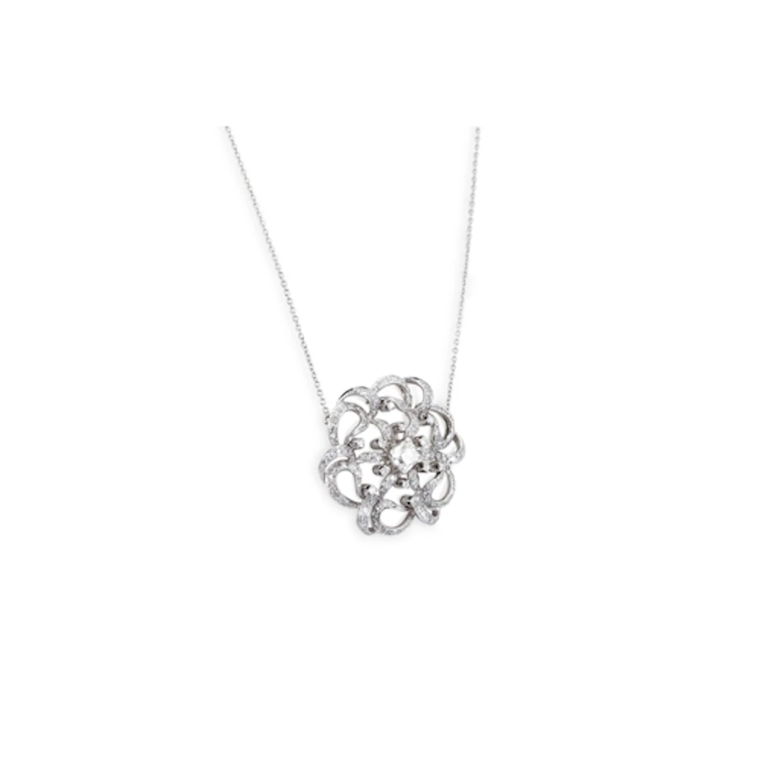A DIAMOND CLUSTER PENDANT, of openwork scrolled form, mounte...