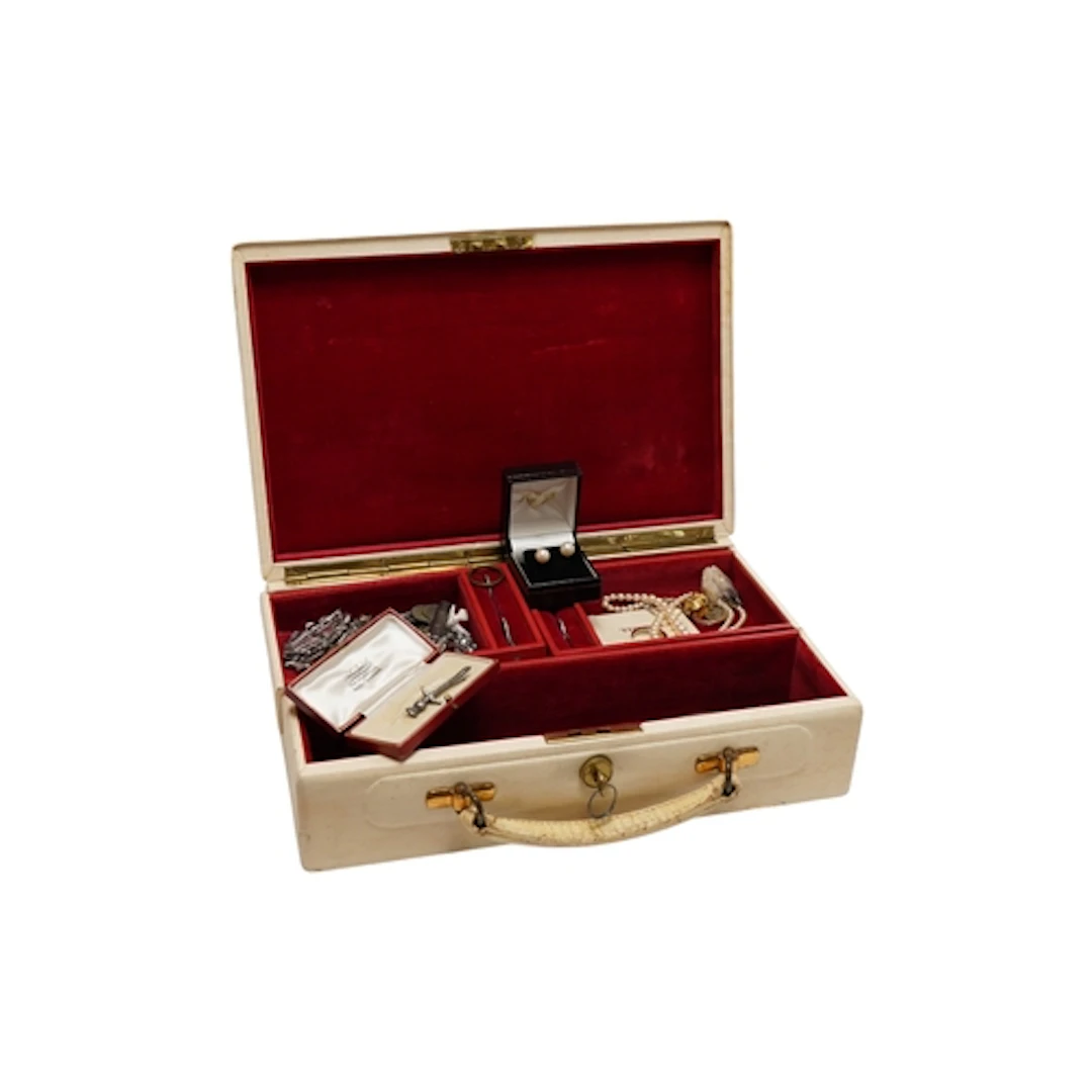A jewellery box containing assorted jewellery and other item...