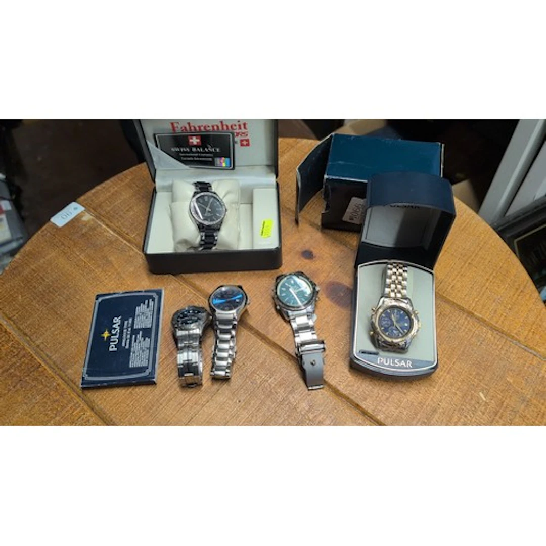 A group of bracelet wristwatches, including a Seiko with bla...
