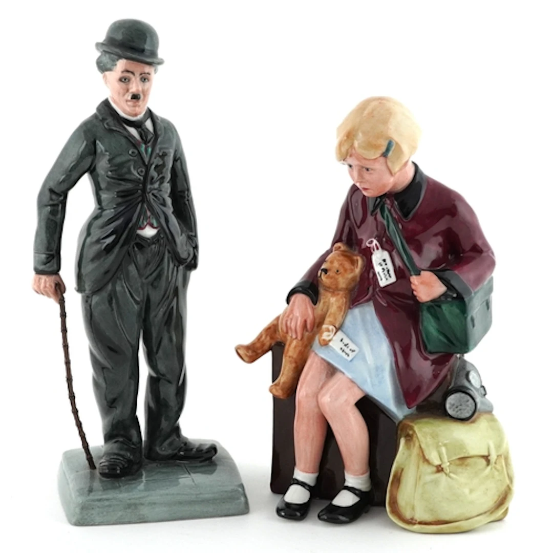 Two Royal Doulton figures comprising Charlie Chaplin numbere...