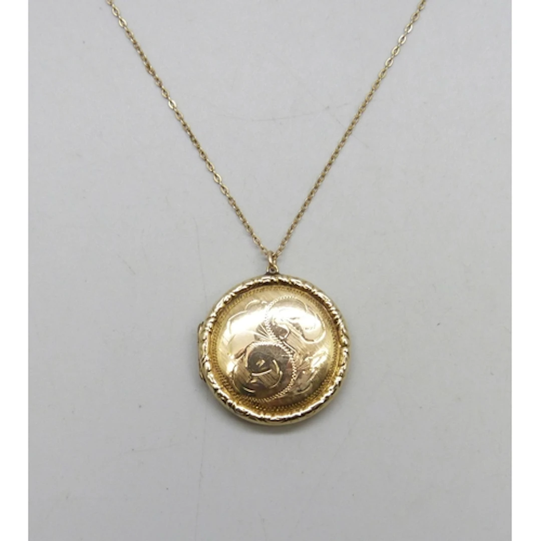 A 9ct gold back and front locket, 3.3cm including bail, on a...