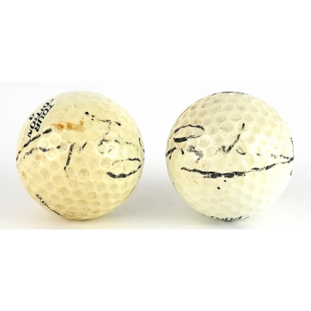 Greg Norman, two signed vintage golf balls.