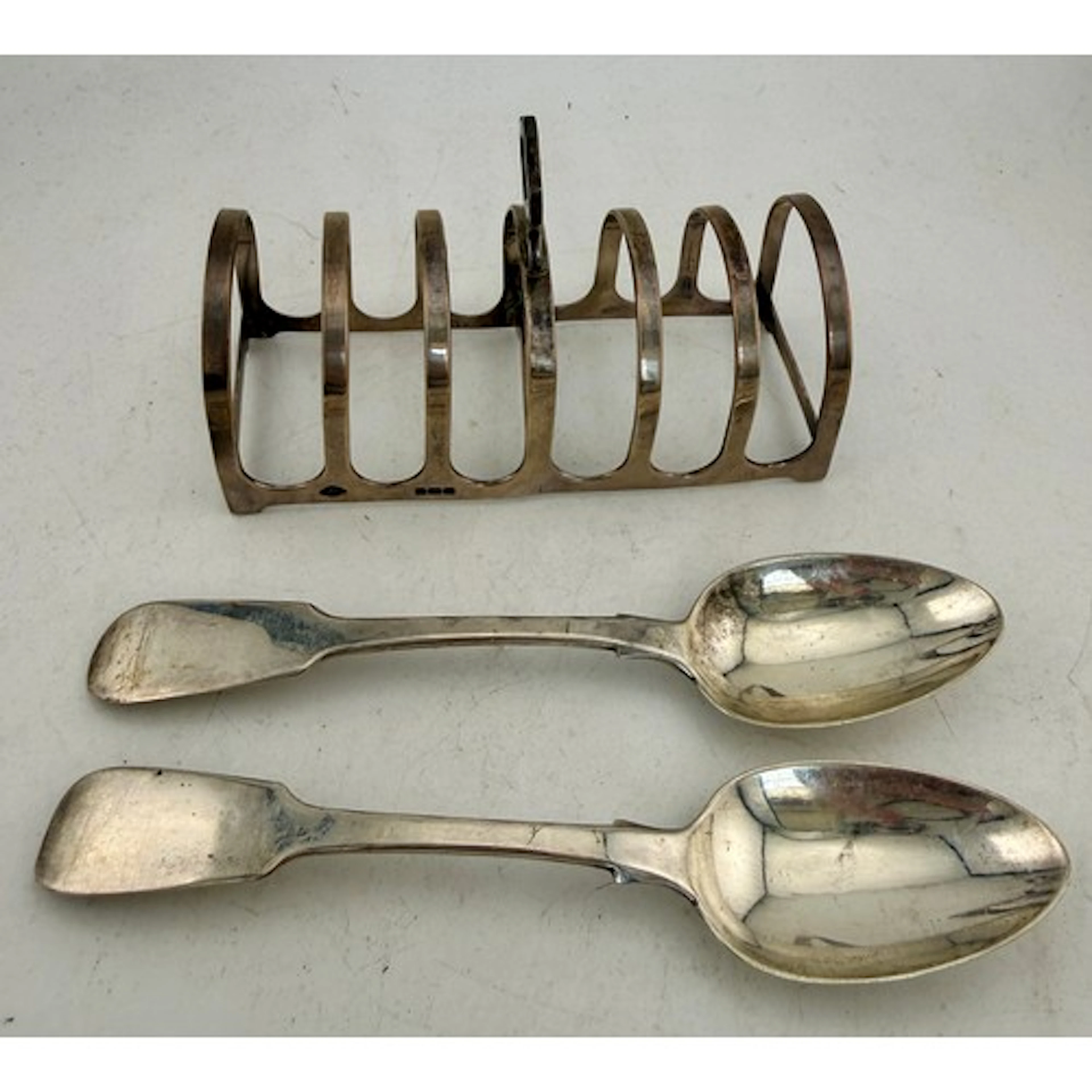 Hallmarked silver toast rack together with two silver spoons...