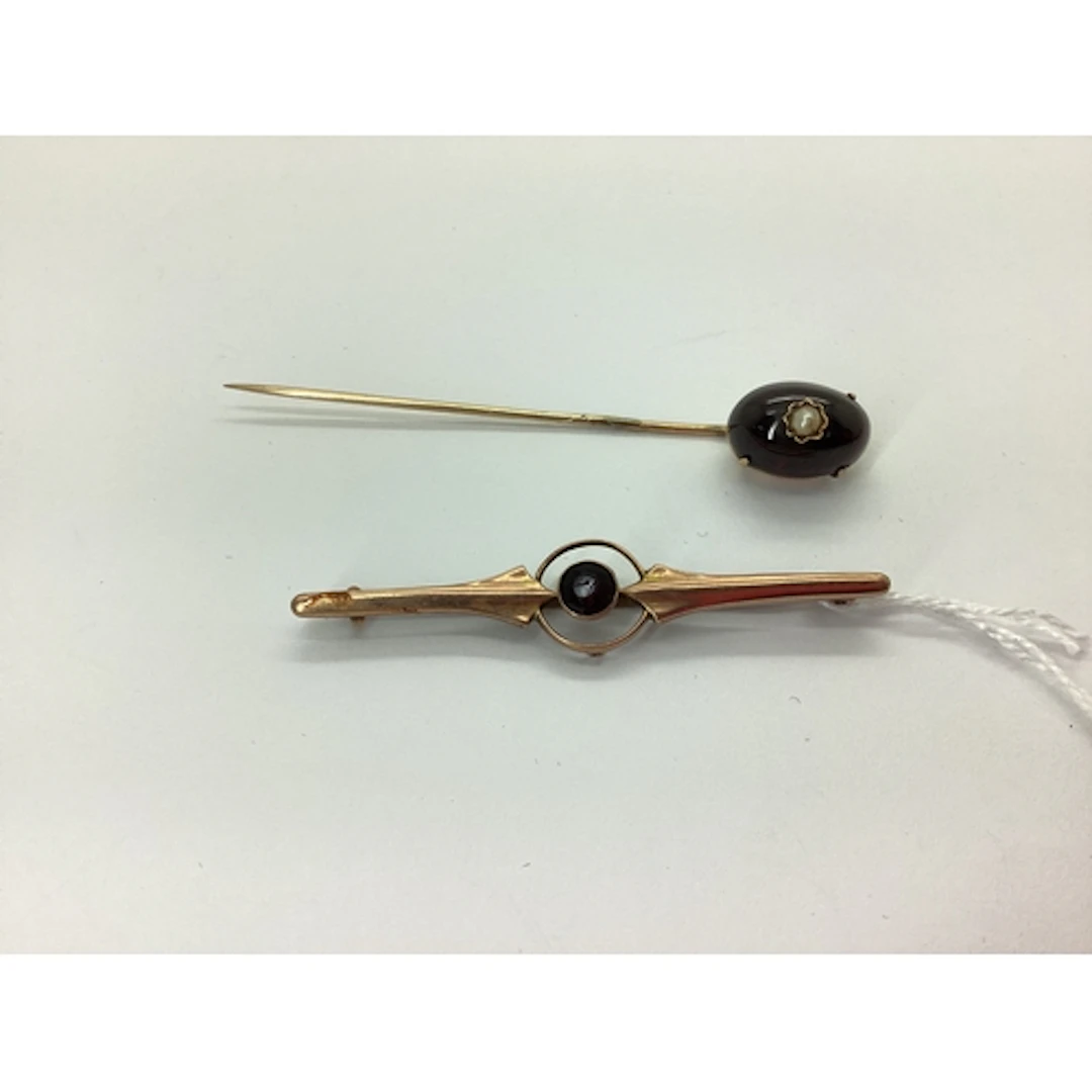 A Victorian Cabochon Garnet Stickpin, oval claw set (one cla...