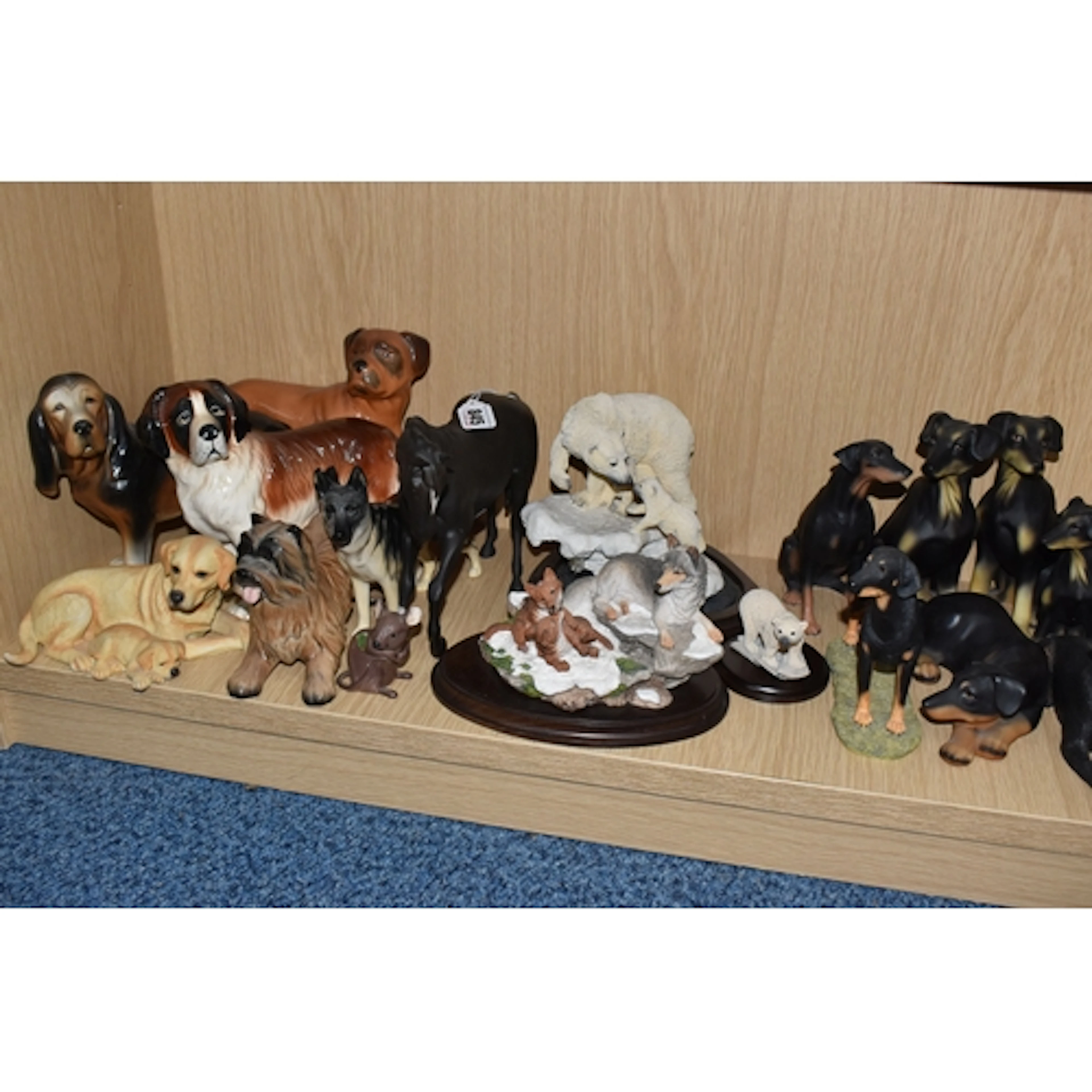 A GROUP OF ANIMAL SCULPTURES, comprising mostly dogs includi...