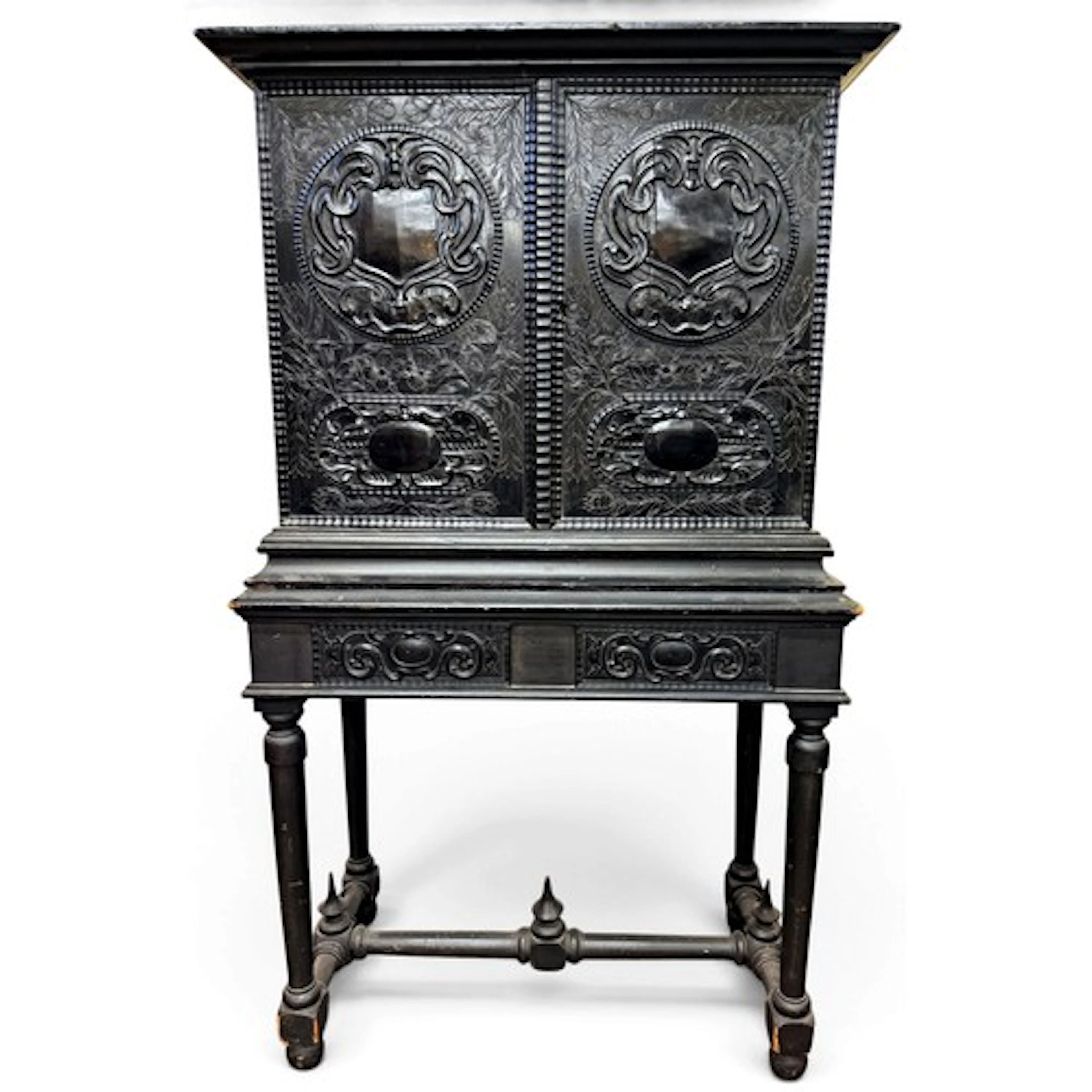 An ebony-veneered cabinet incorporating a pair of richly car...