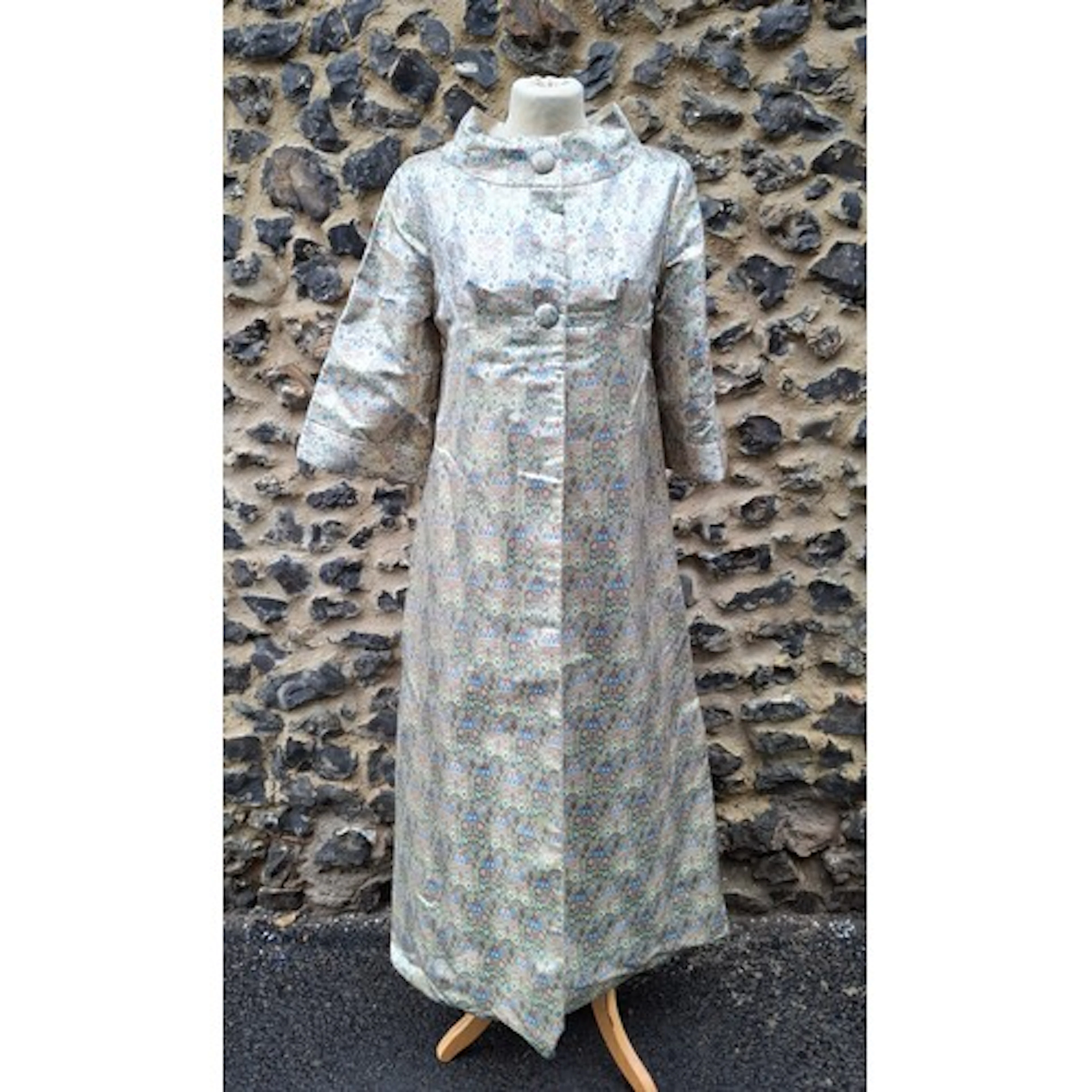 A 1960's opera/evening coat in a metallic gold silk and flor...