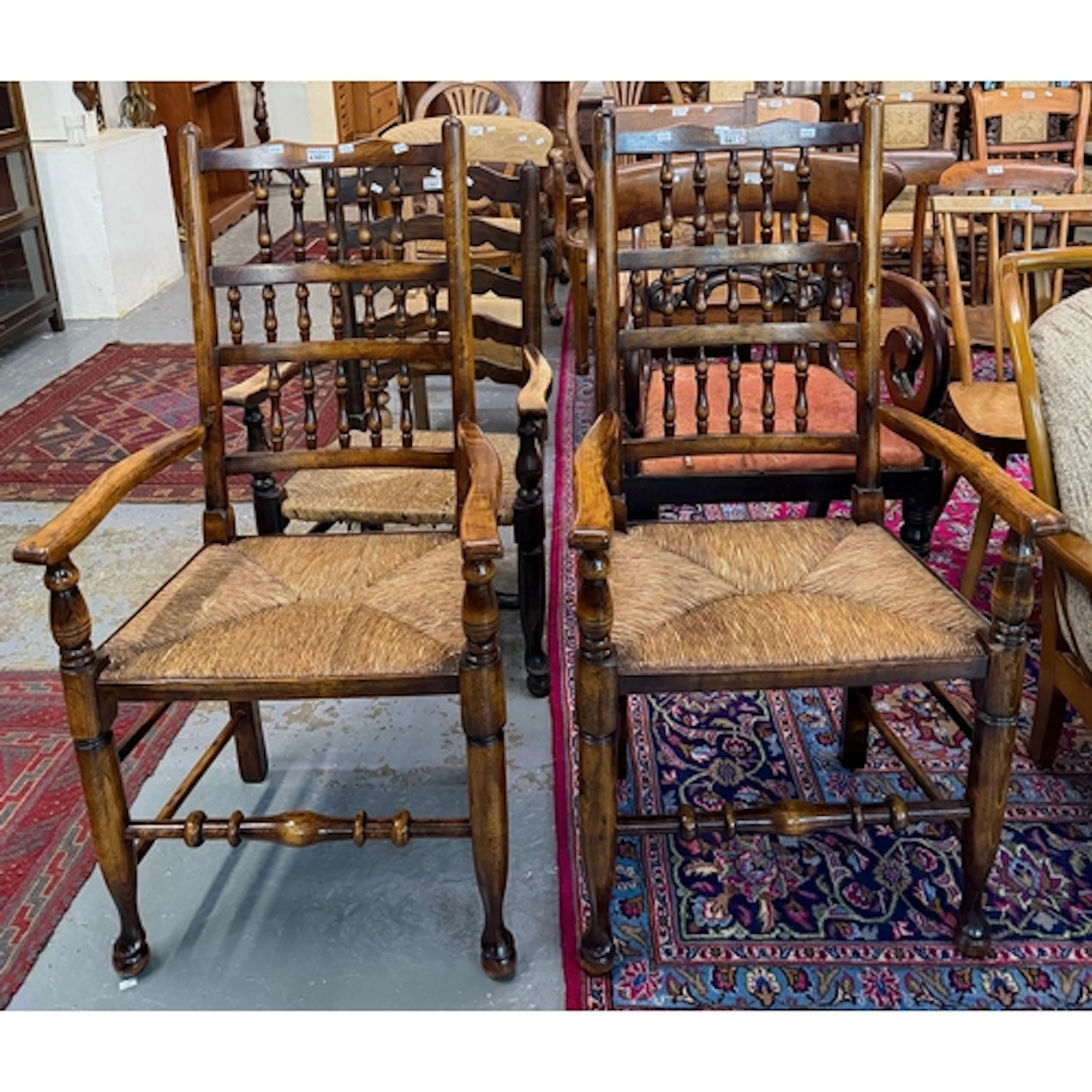 Pair of Lancashire style spindle-backed oak elbow chairs wit...