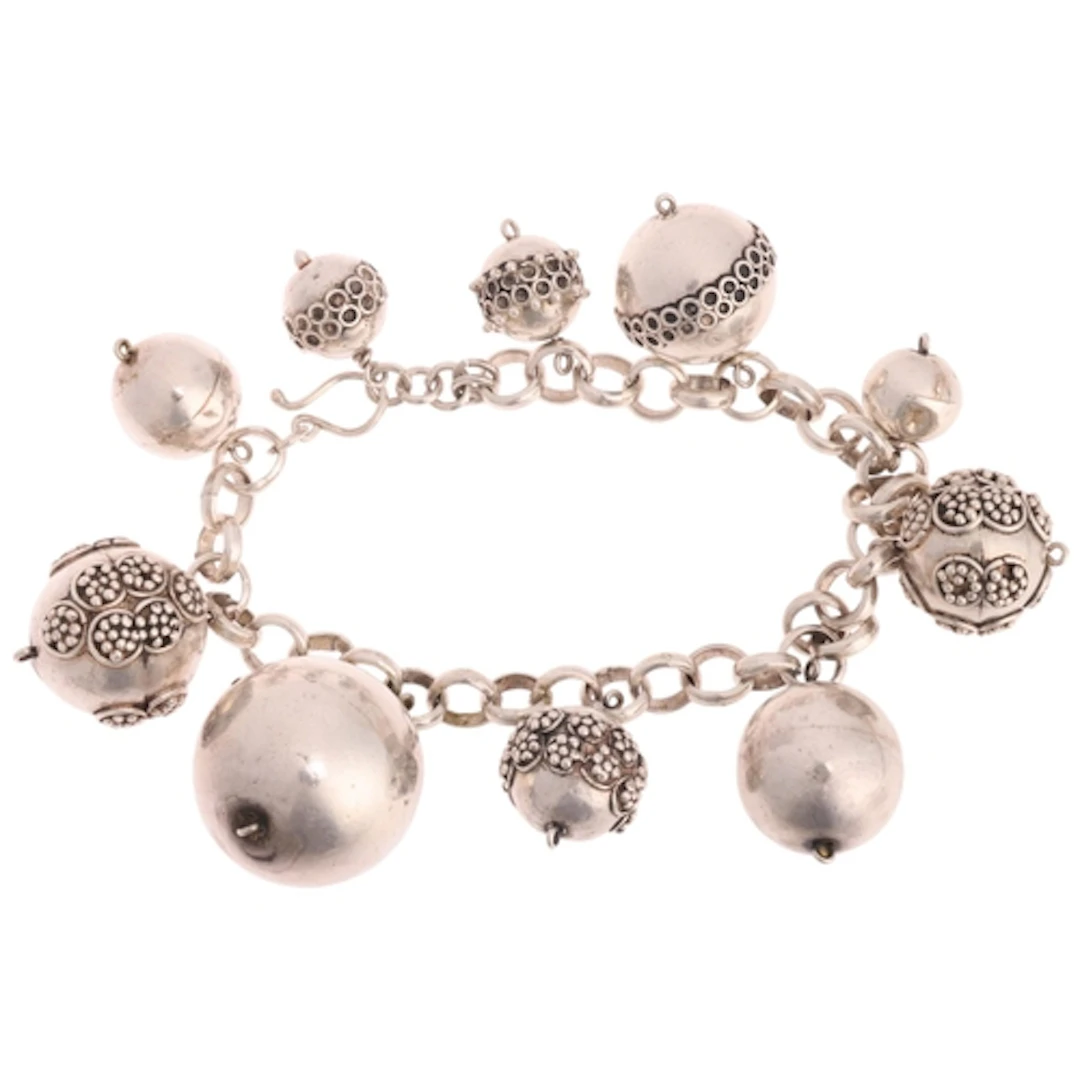An Indonesian silver bead charm bracelet, beads measure: 23....