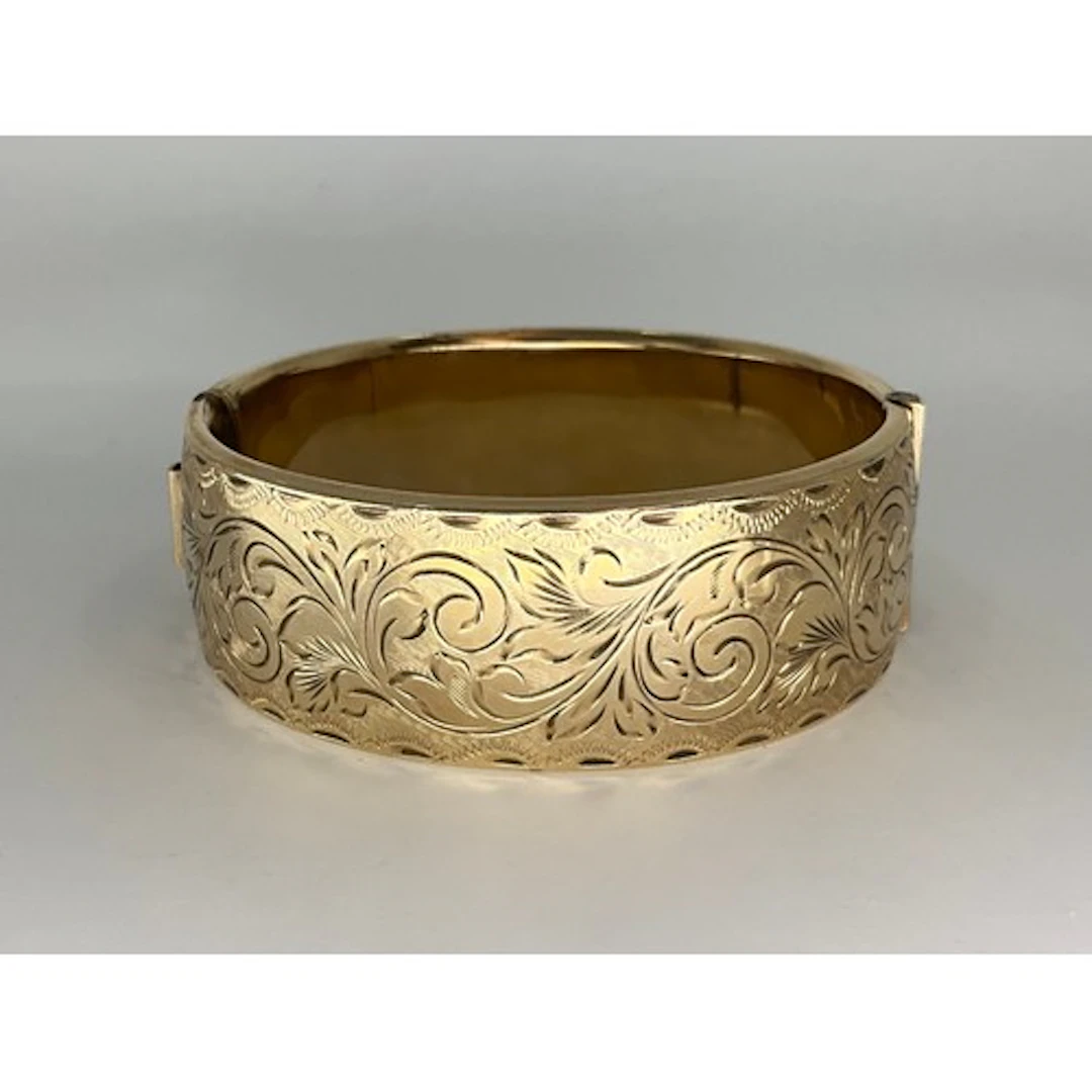 A 1960's Reynolds and Westwood 9ct gold metal core bangle (5...