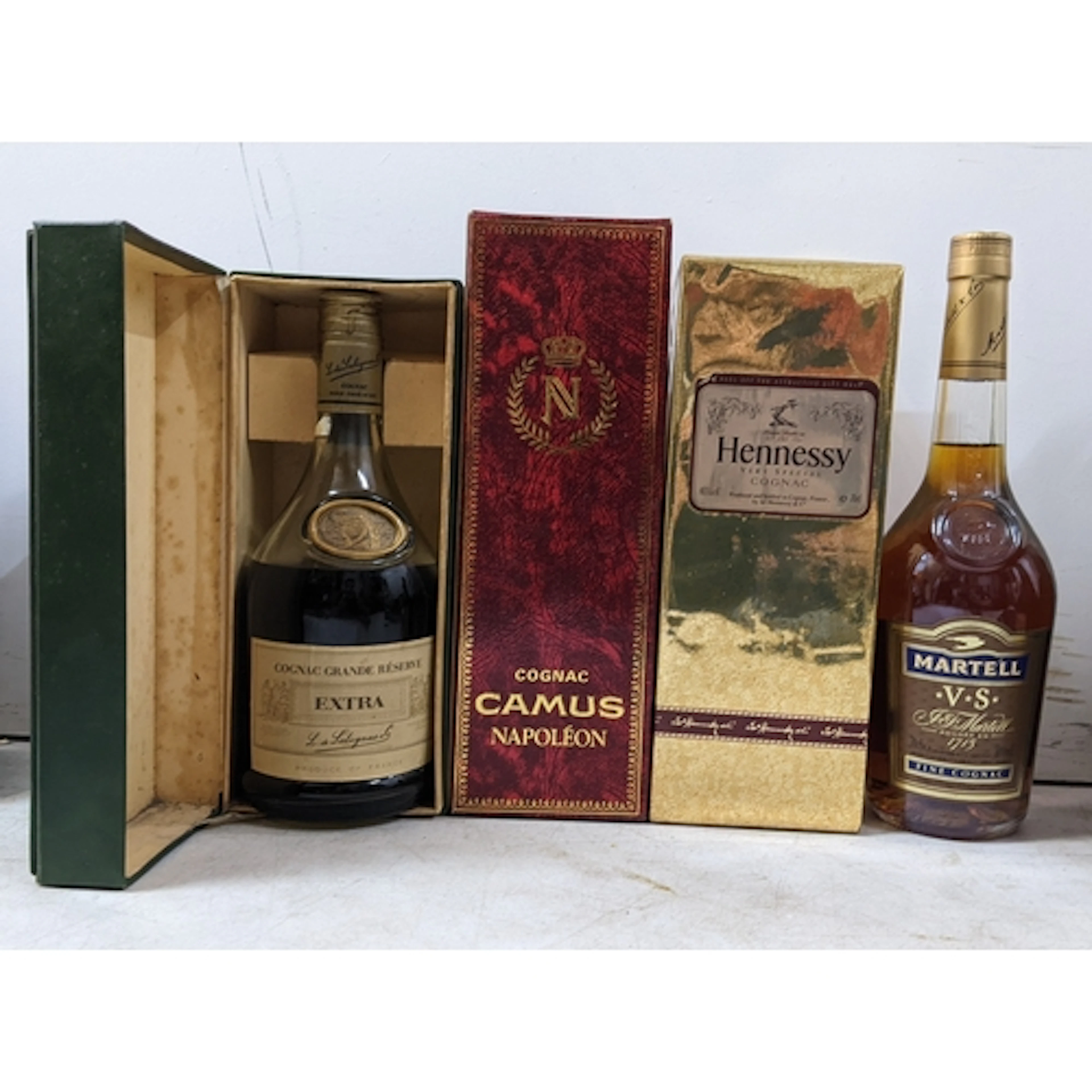 A group of four bottles of Cognac, comprising: - Martell VS ...