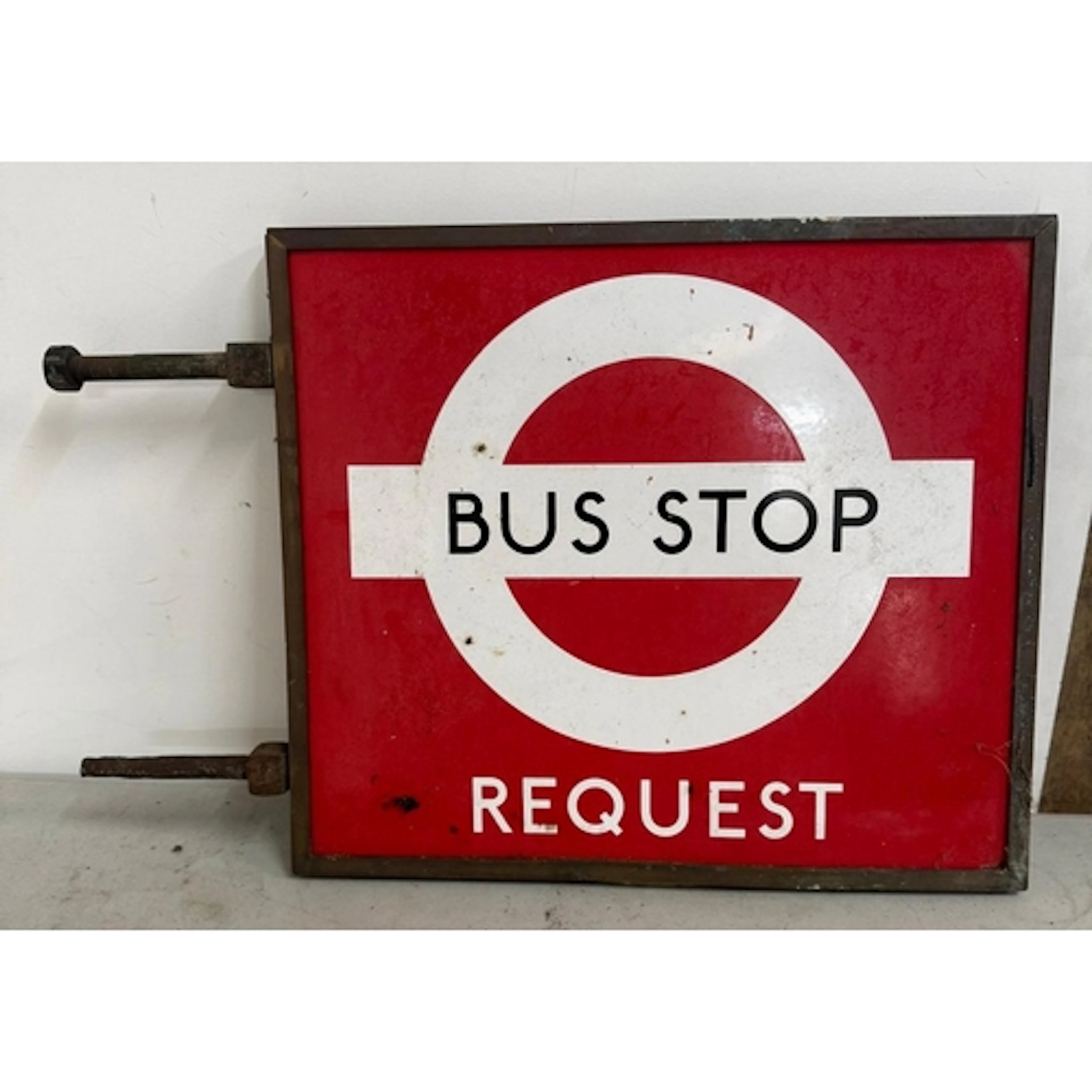A vintage enamel bus stop request sign.