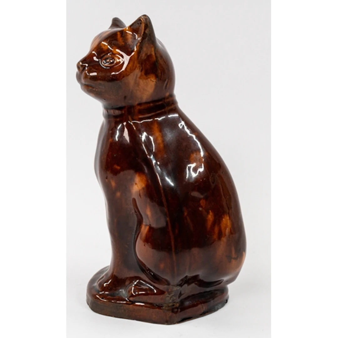 Ceramics: A slipware figure of a cat, 19th century, seated o...