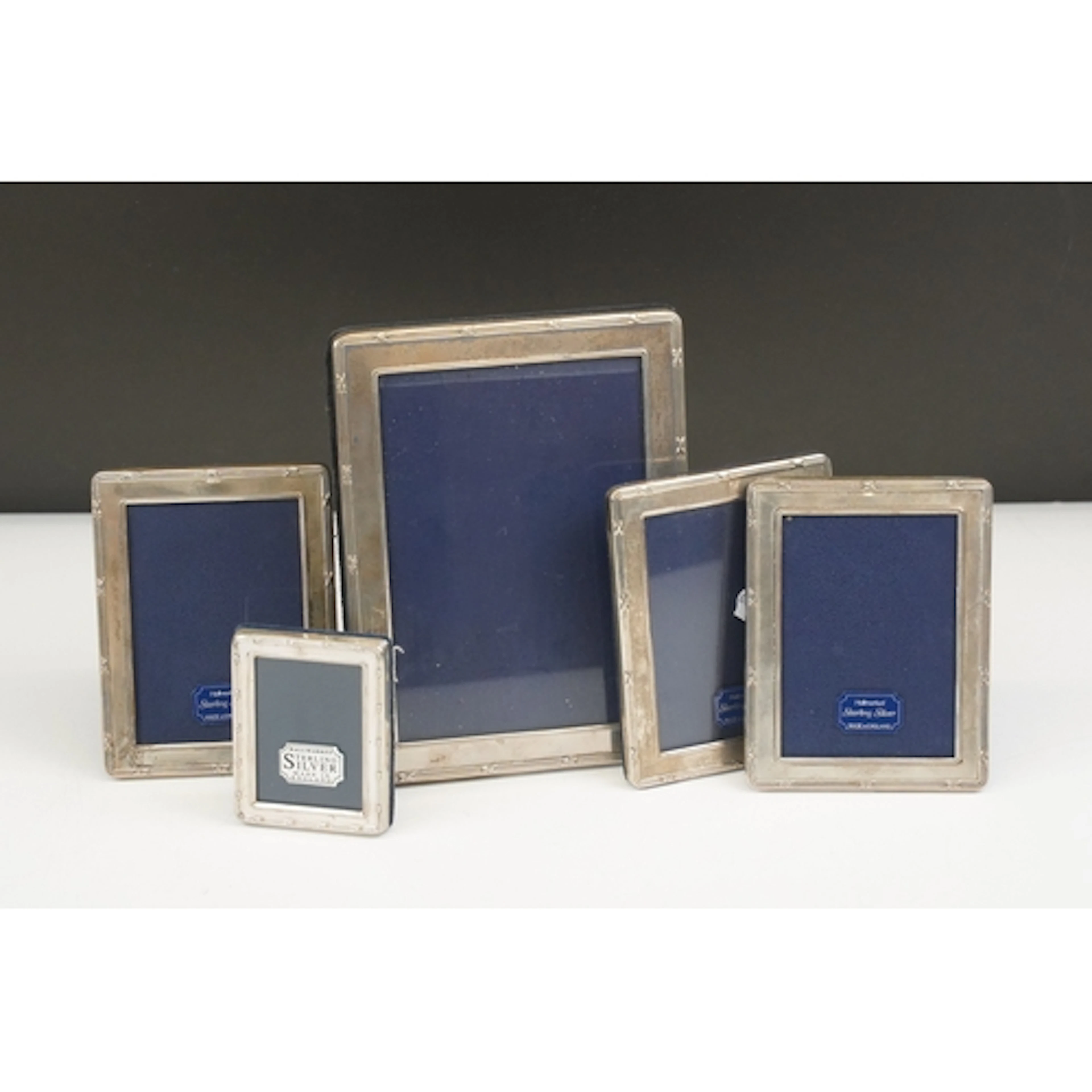 Five sterling silver easel back photo frames of graduating s...