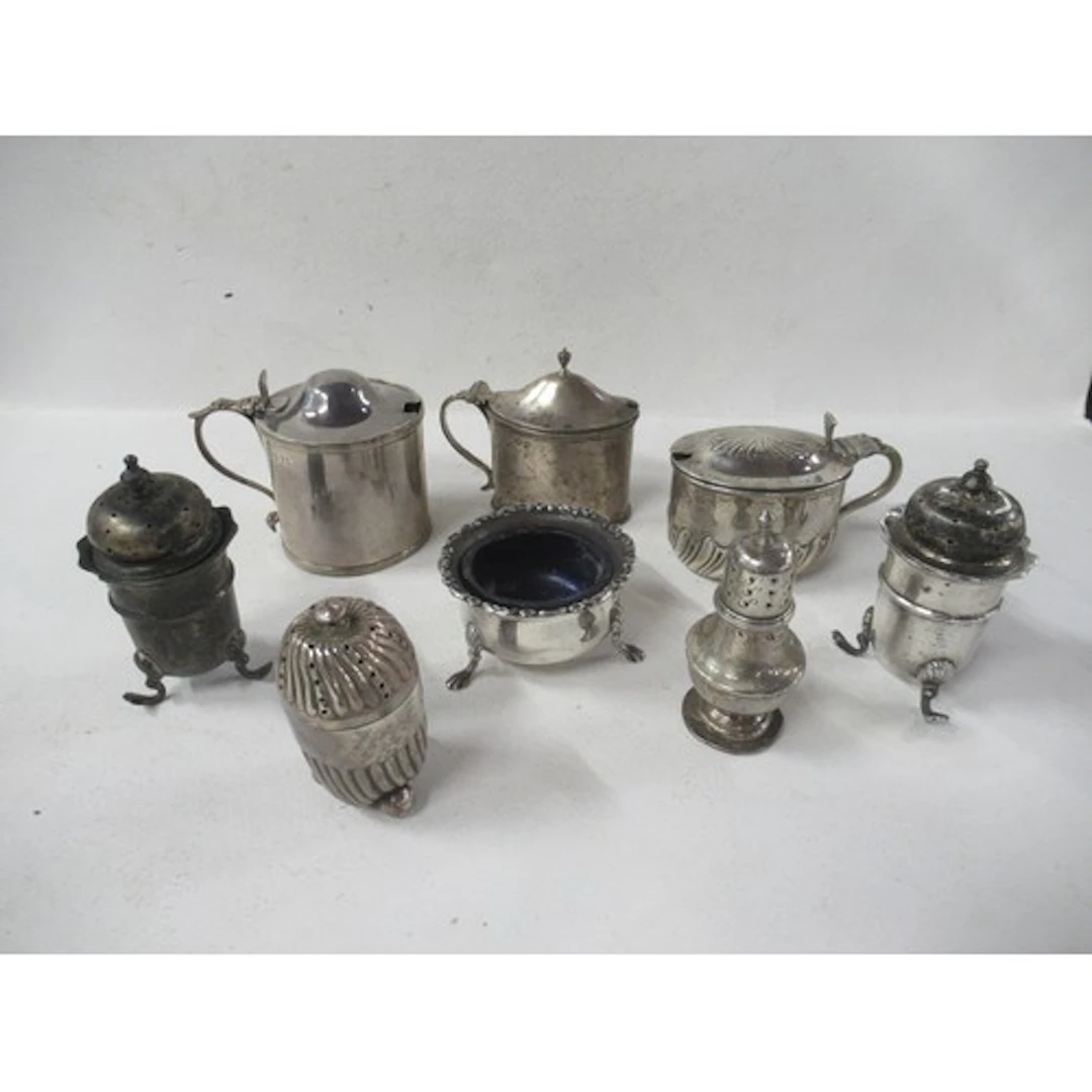 A collection of silver condiment pots