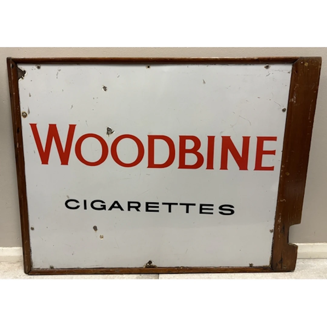 A vintage enamel "Woodbine Cigarettes" advertising sign. App...