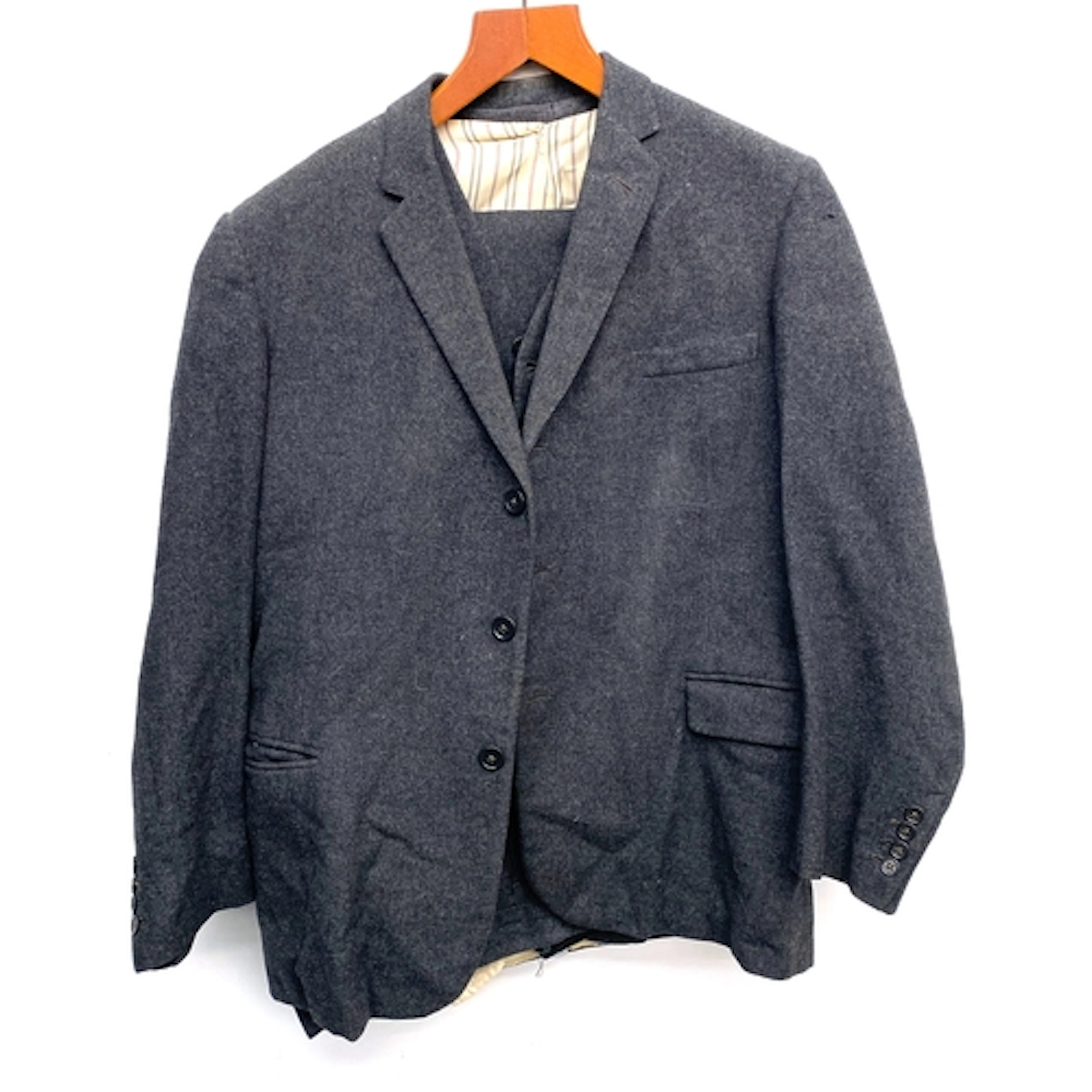 A single breasted three piece grey flannel suit, tailored by...