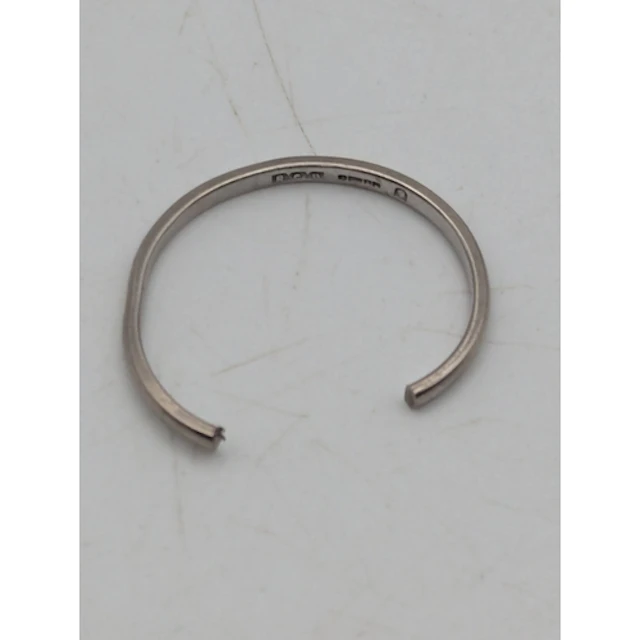 An 18ct white gold wedding band A/F, stamped 750 with Britis...