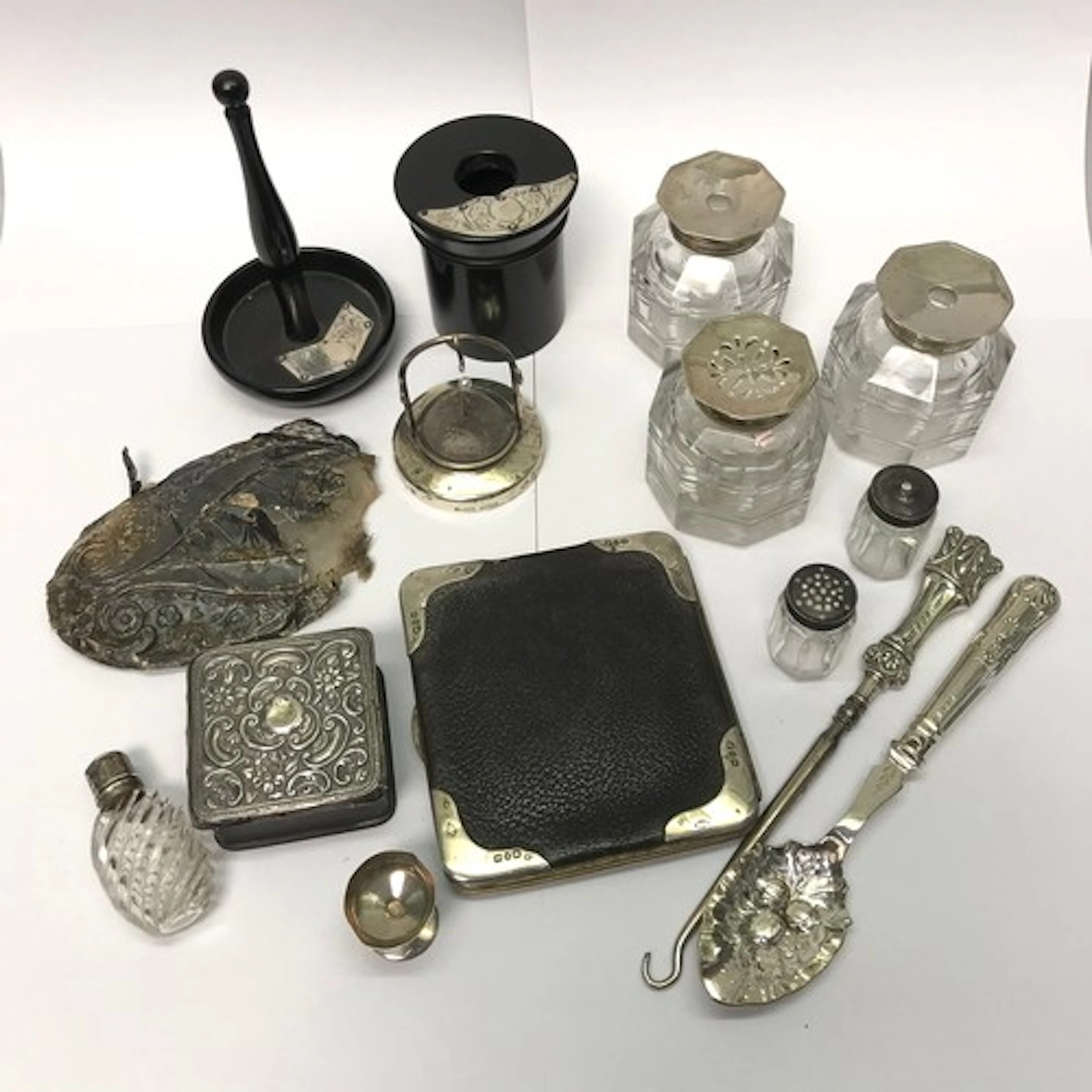 A pair of Georgian silver topped glass inkwells with a match...