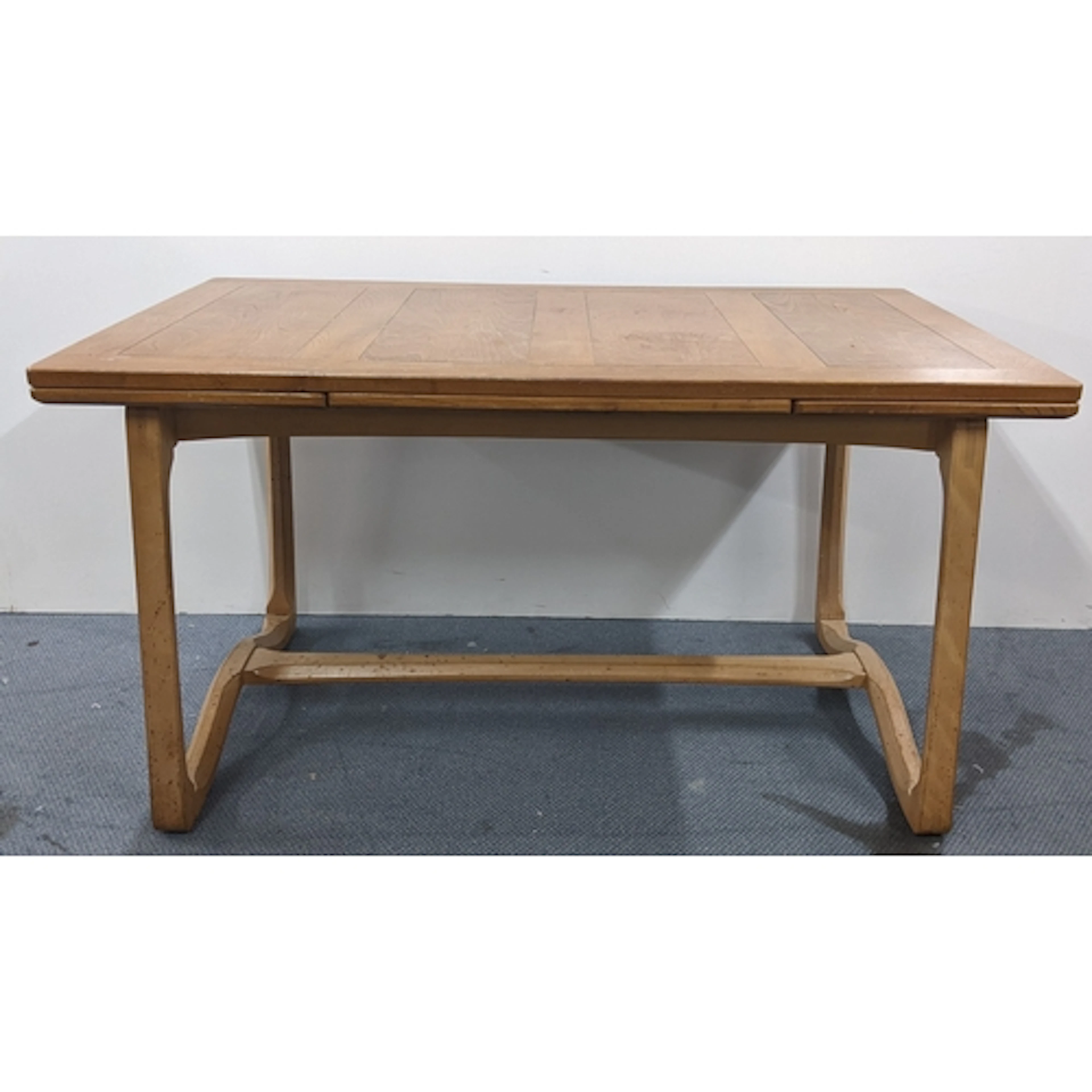 A mid 20th century Ercol elm and beech draw leaf dining tabl...