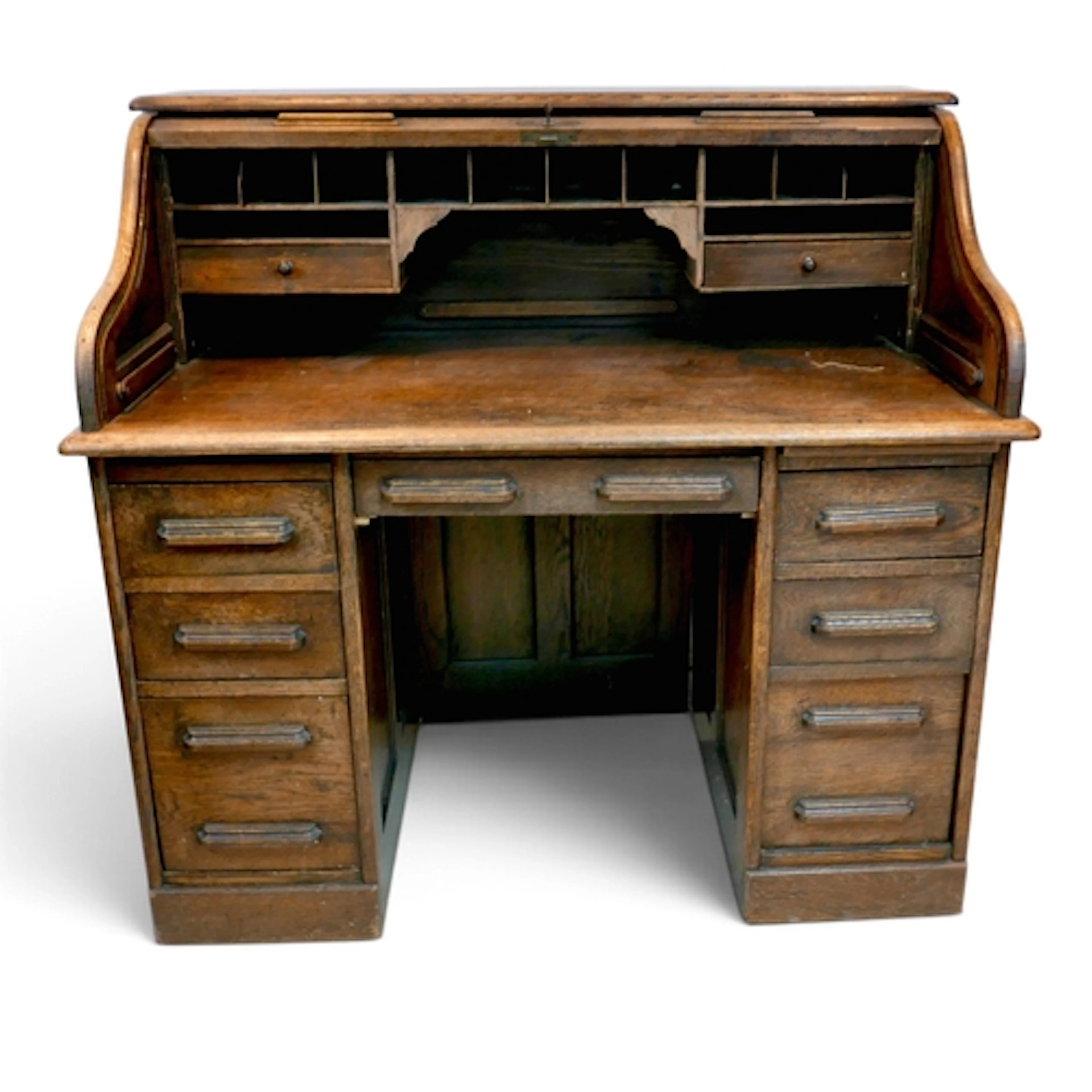 AN EARLY 1900'S OAK ROLL TOP KNEEHOLE DESK. with a fitted in...