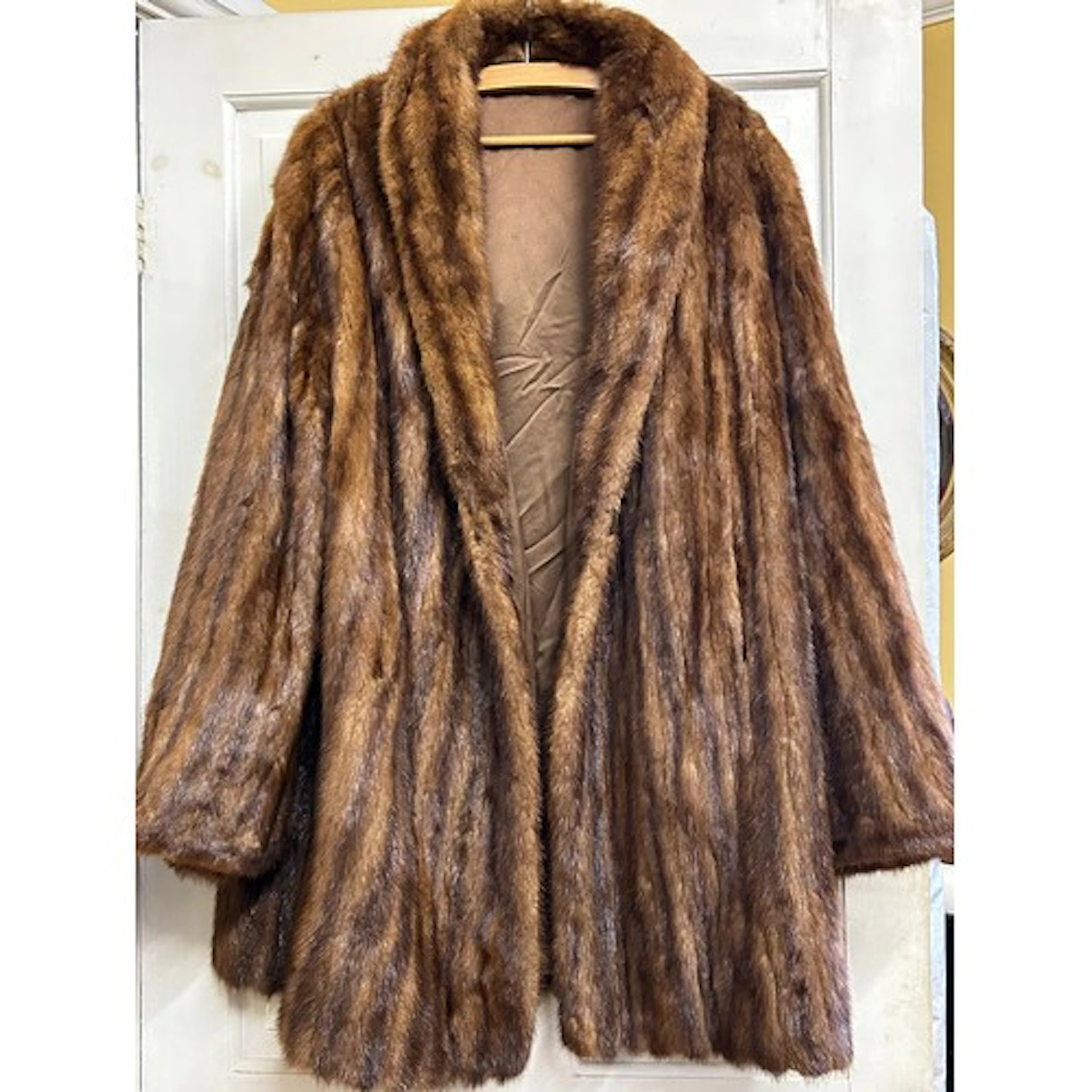 A vintage Musquash fur coat with long wide sleeves, two pock...