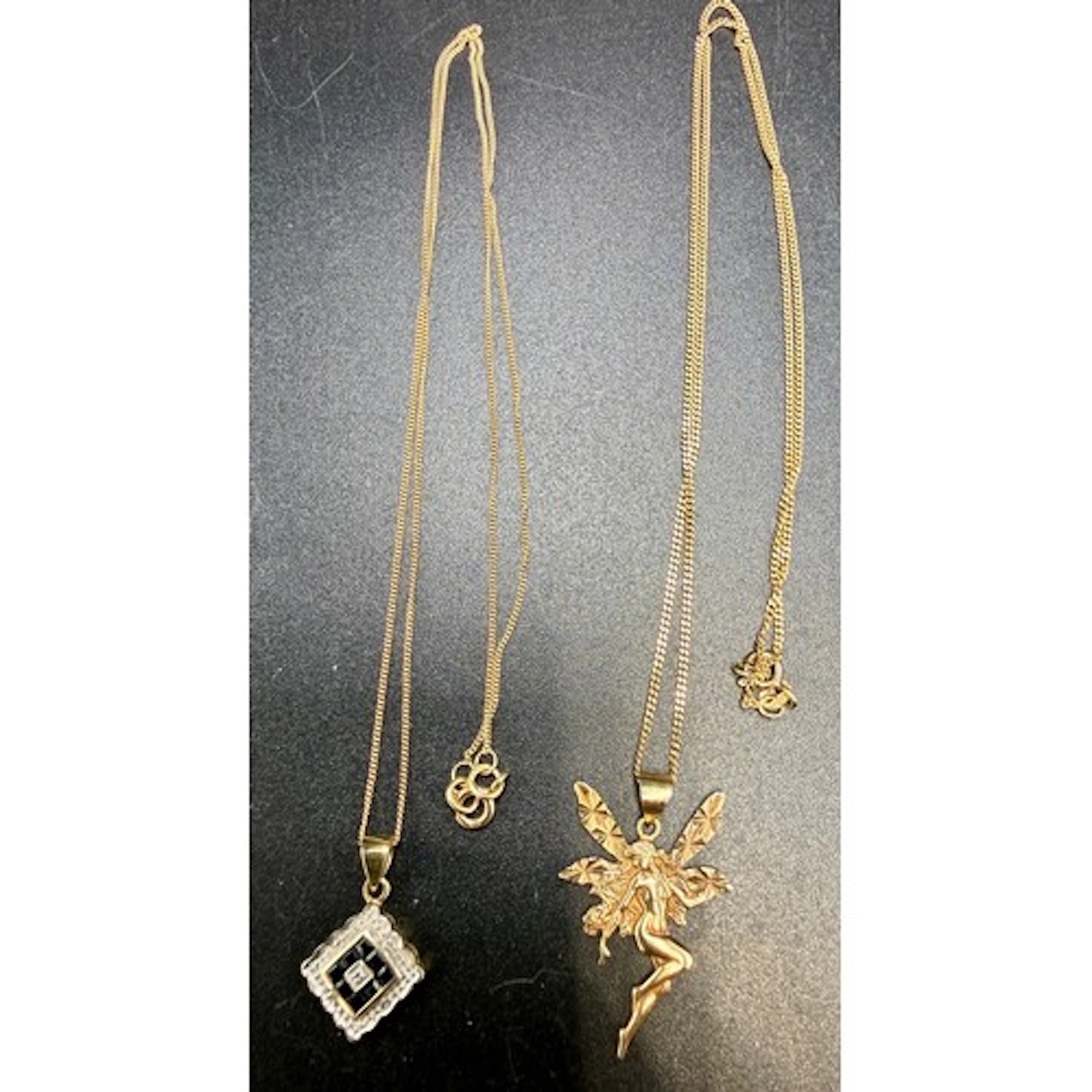 Two 9 carat gold pendants, one with fairy, the other with se...
